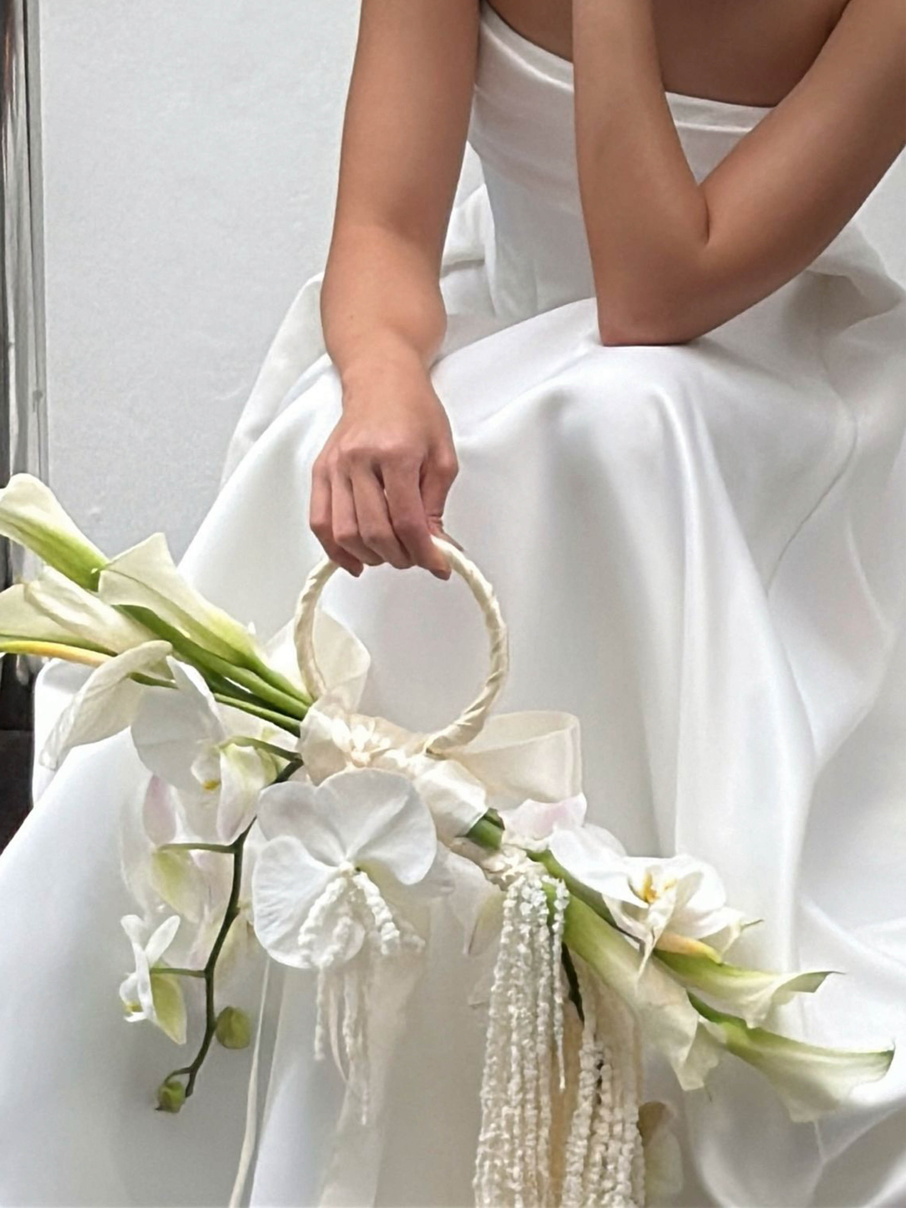 Top 2025 Bridal Bouquet and Wedding Trend. Custom Bridal Bouquet Bag made with white Calla Lilies and Orchid, crafted by Eden's Ground.