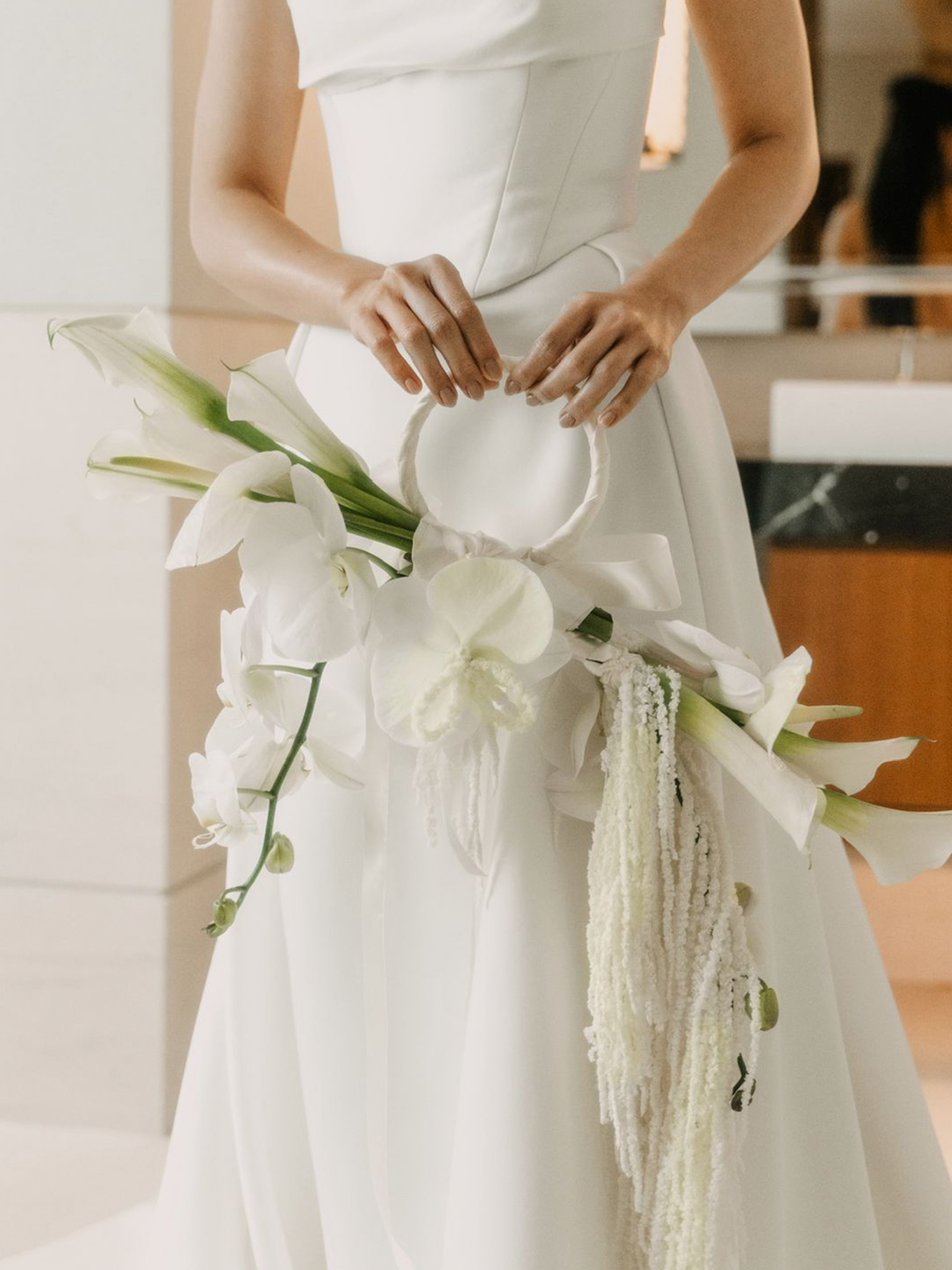 Top 2025 Bridal Bouquet and Wedding Trend. Custom Bridal Bouquet Bag made with white Calla Lilies and Orchid, crafted by Eden's Ground.