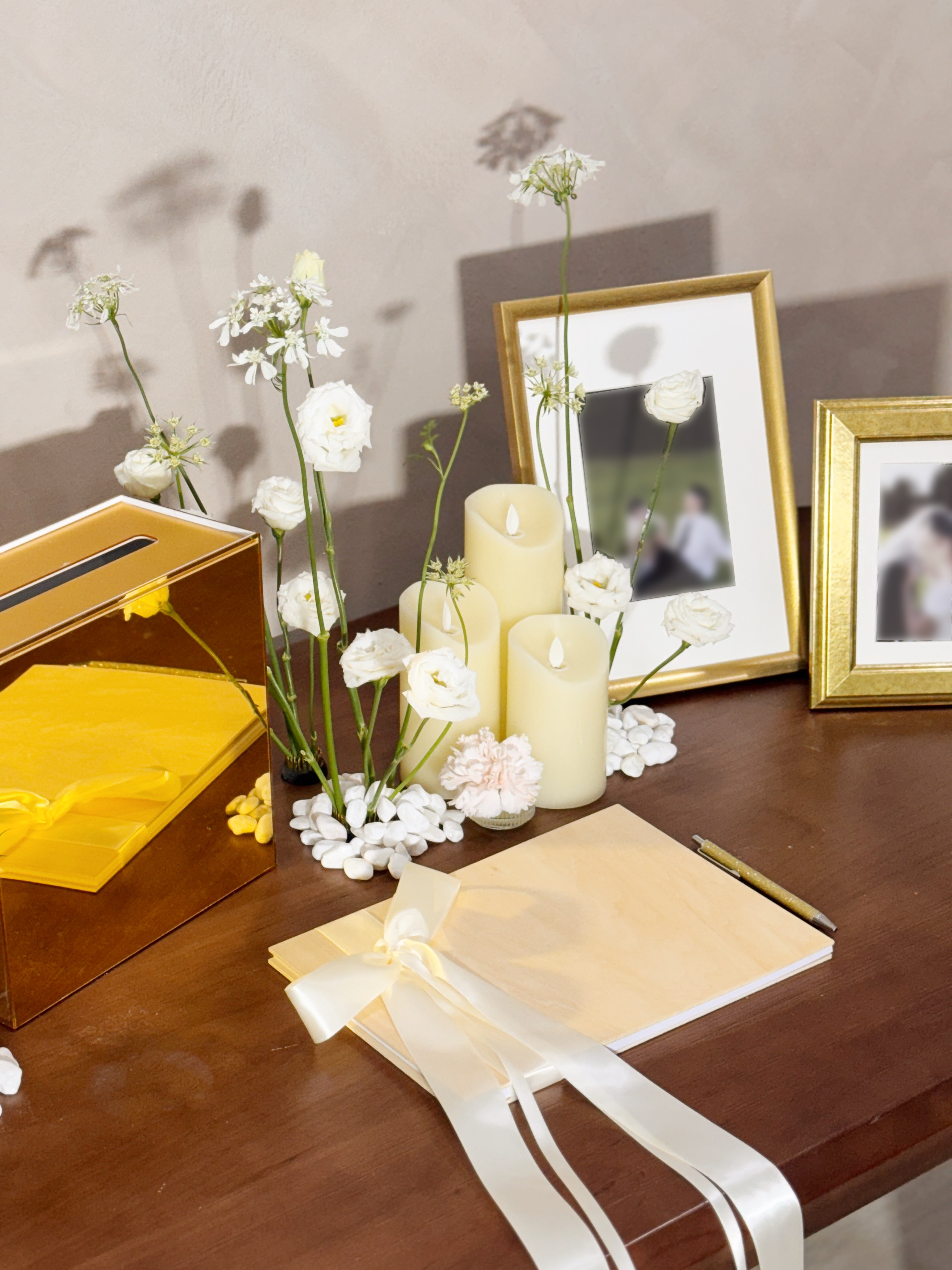 Wedding reception table setting with framed photos, candles, and flowers. Styled by Eden's Ground, a floral design boutique.
