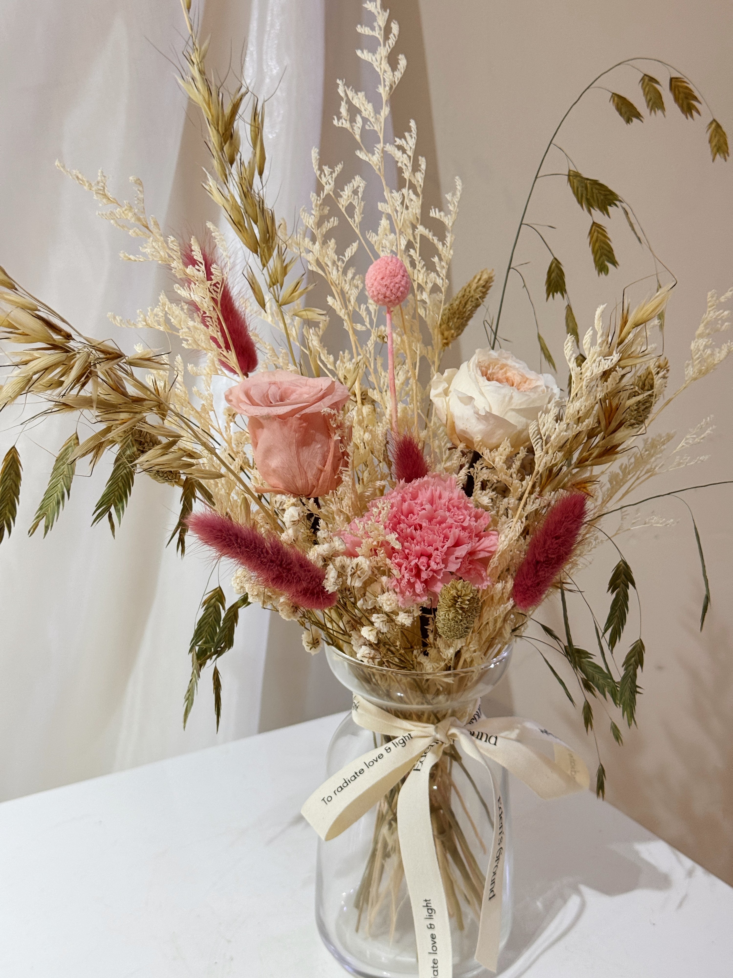 A Love That Lasts vase arrangement by Eden’s Ground featuring everlasting florals in sweet, pink love-filled colours, with roses, carnations etc — thoughtfully styled in a vase. Low-maintenance and long-lasting, it's perfect as a Mother's Day gift or as a timeless piece of home décor.