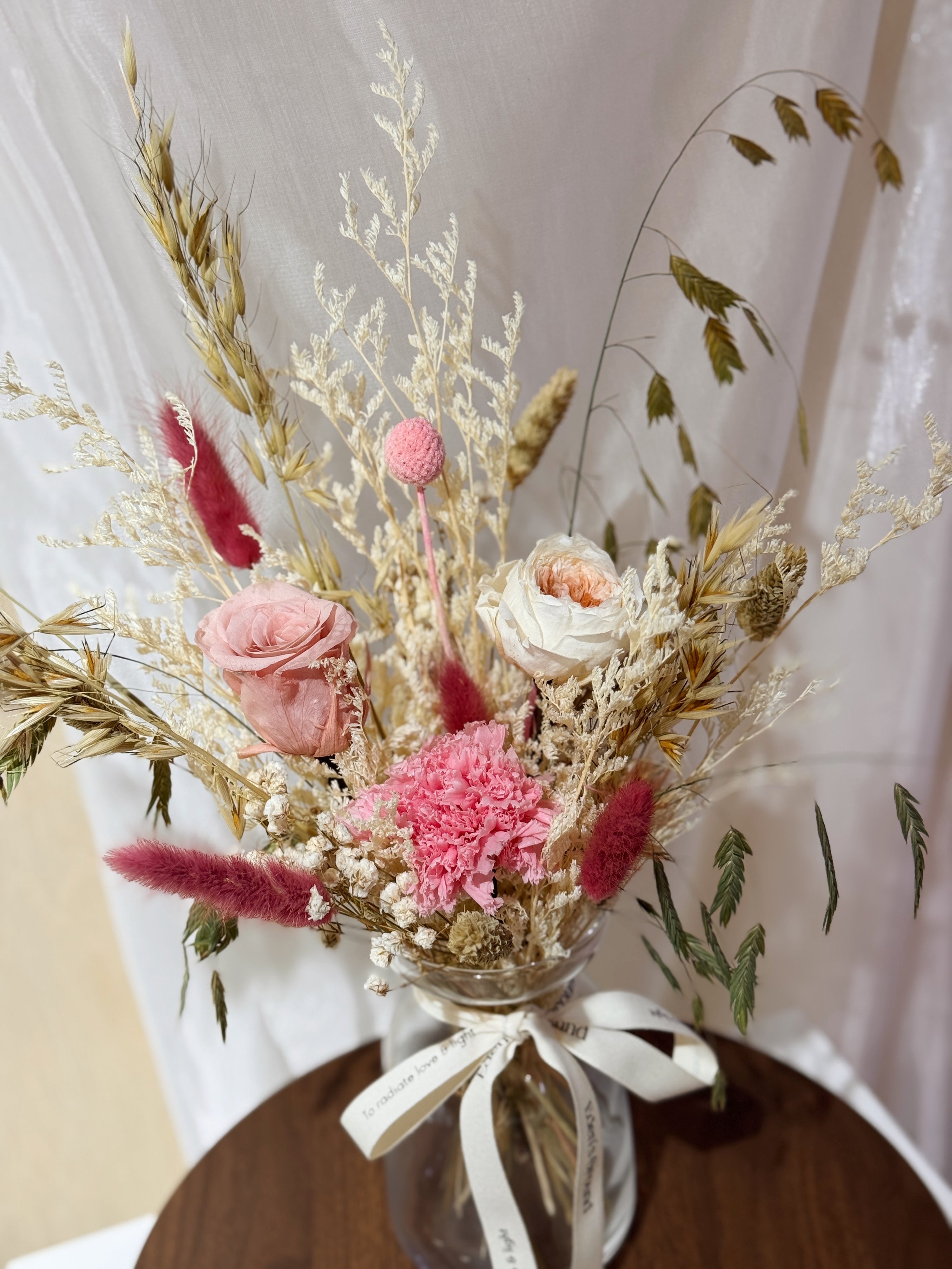 A Love That Lasts vase arrangement by Eden’s Ground featuring everlasting florals in sweet, pink love-filled colours, with roses, carnations etc — thoughtfully styled in a vase. Low-maintenance and long-lasting, it's perfect as a Mother's Day gift or as a timeless piece of home décor.