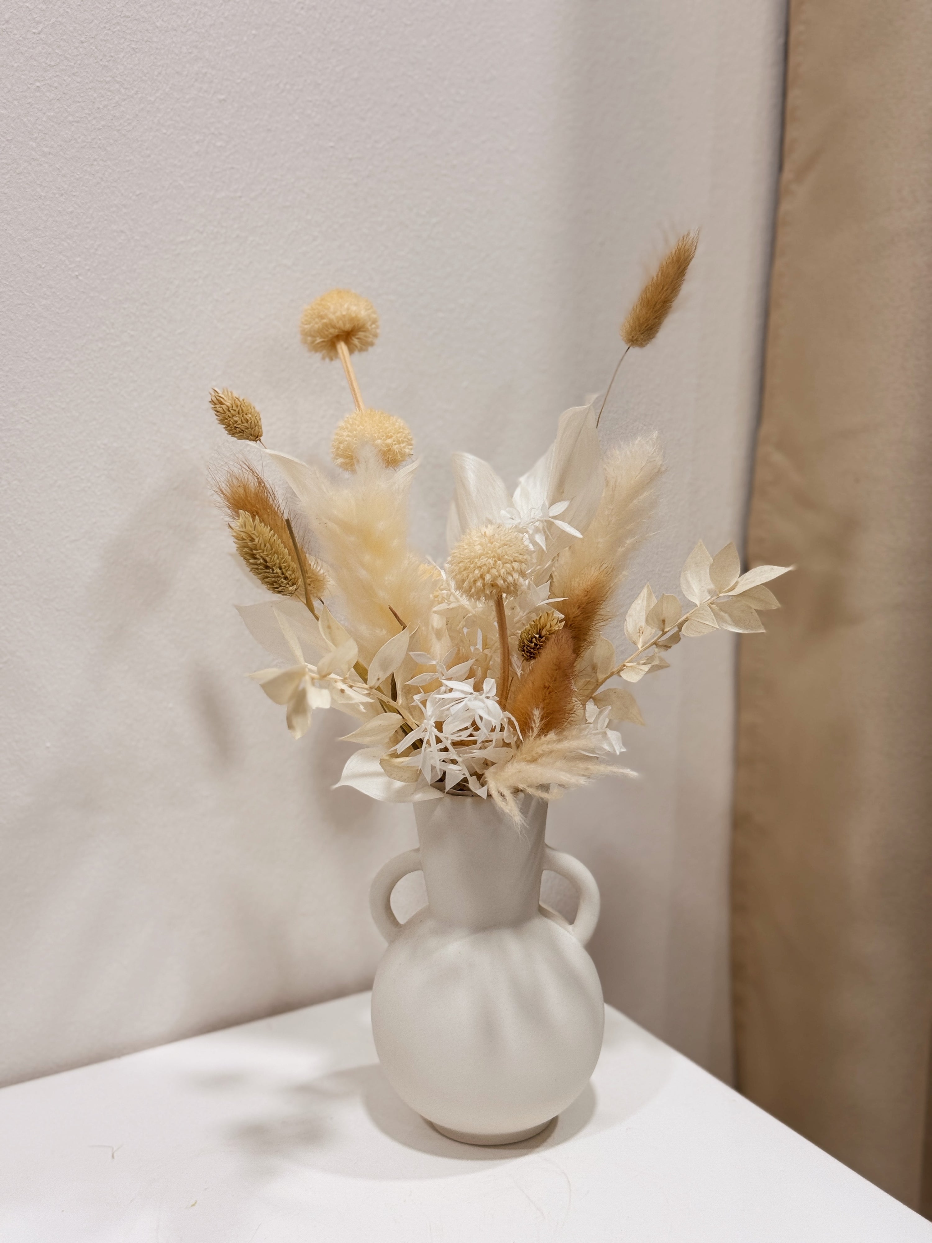 The Alabaster Field vase arrangement by Eden’s Ground featuring everlasting florals in soft, earthy tones — thoughtfully styled in a matte porcelain vase. Low-maintenance and long-lasting, it's perfect as a housewarming gift or as a timeless piece of home décor.