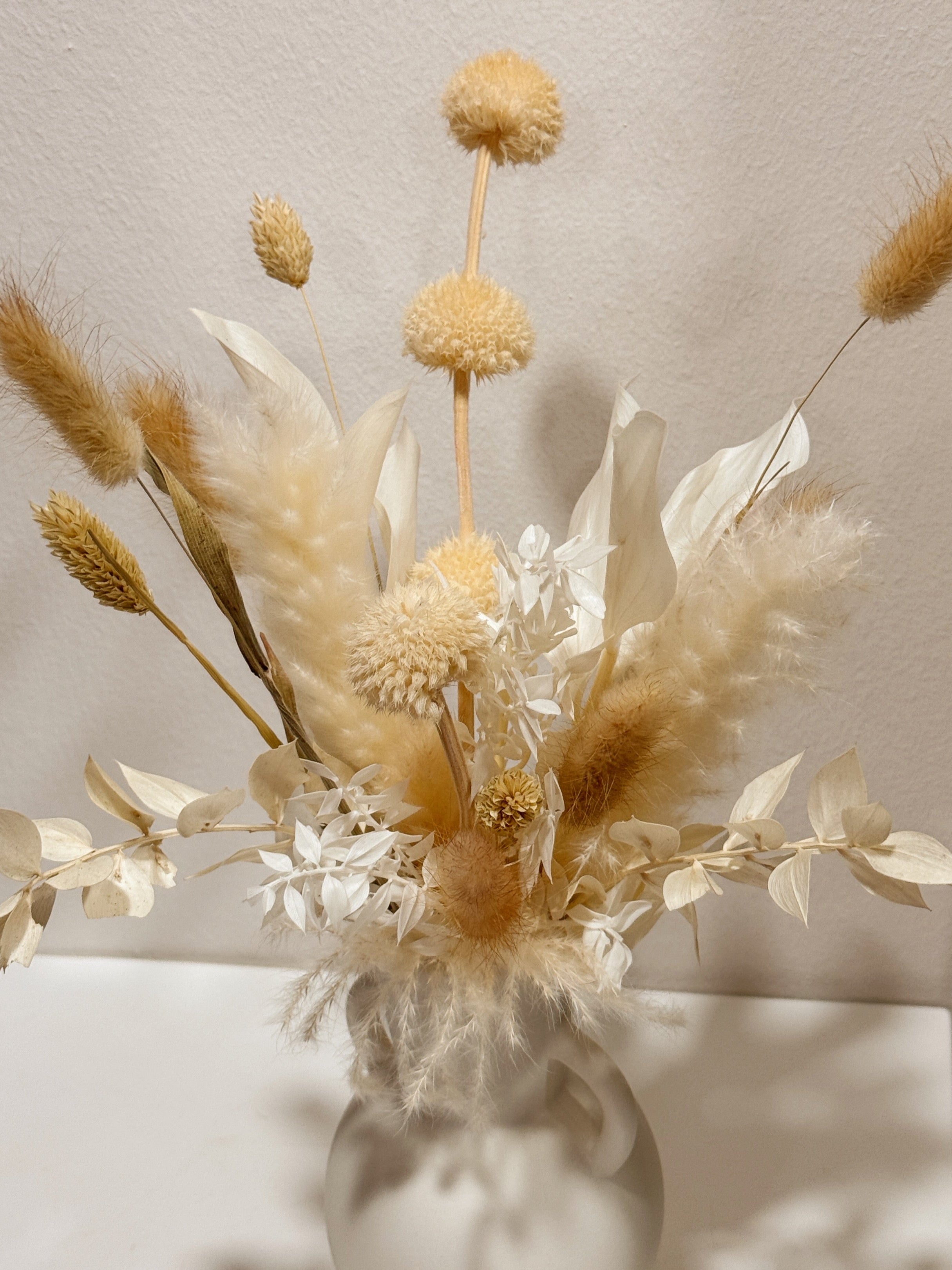The Alabaster Field vase arrangement by Eden’s Ground featuring everlasting florals in soft, earthy tones — thoughtfully styled in a matte porcelain vase. Low-maintenance and long-lasting, it's perfect as a housewarming gift or as a timeless piece of home décor.
