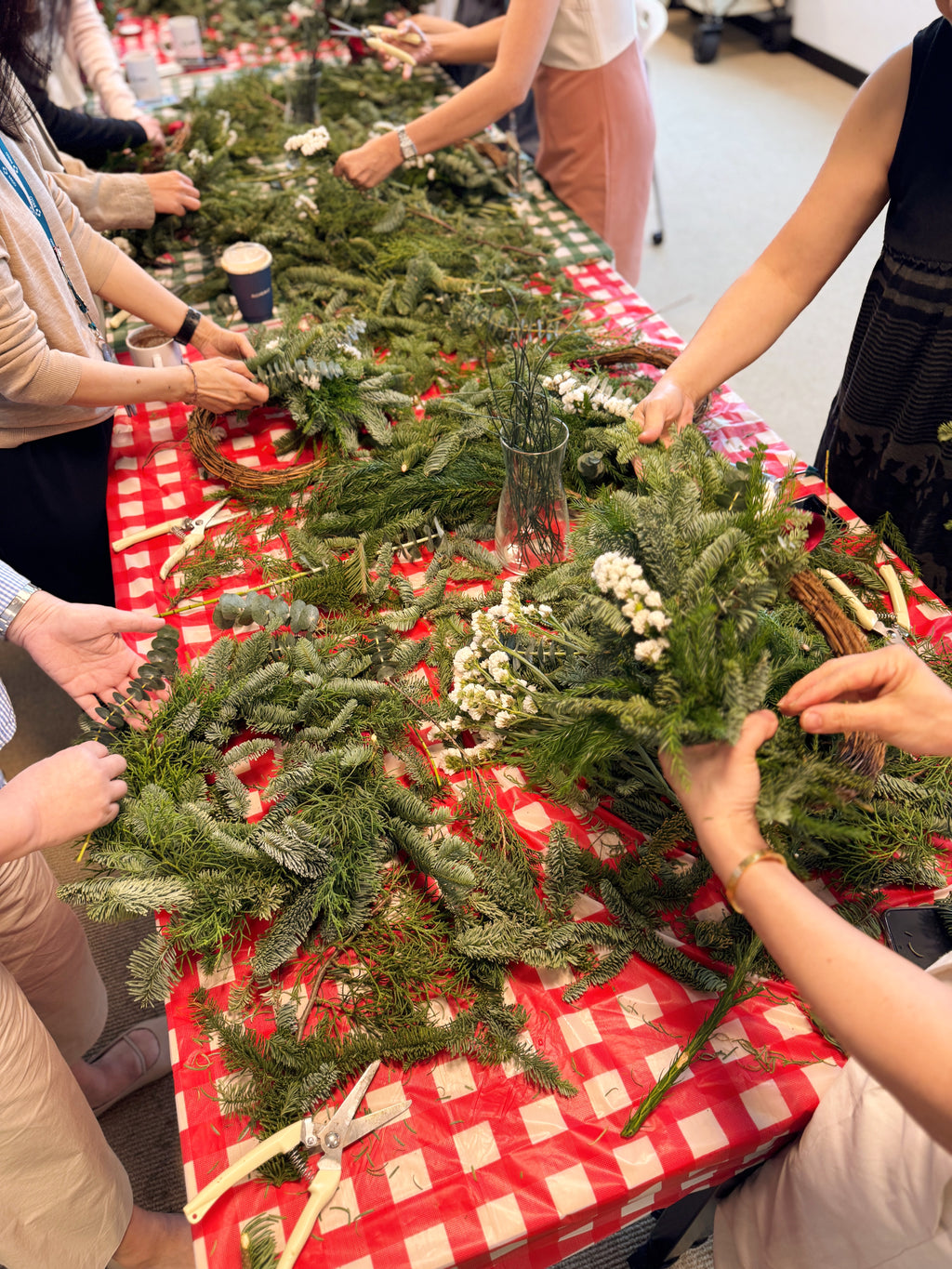 People working on Christmas wreaths, b2b team bonding workshop by Eden's Ground.
