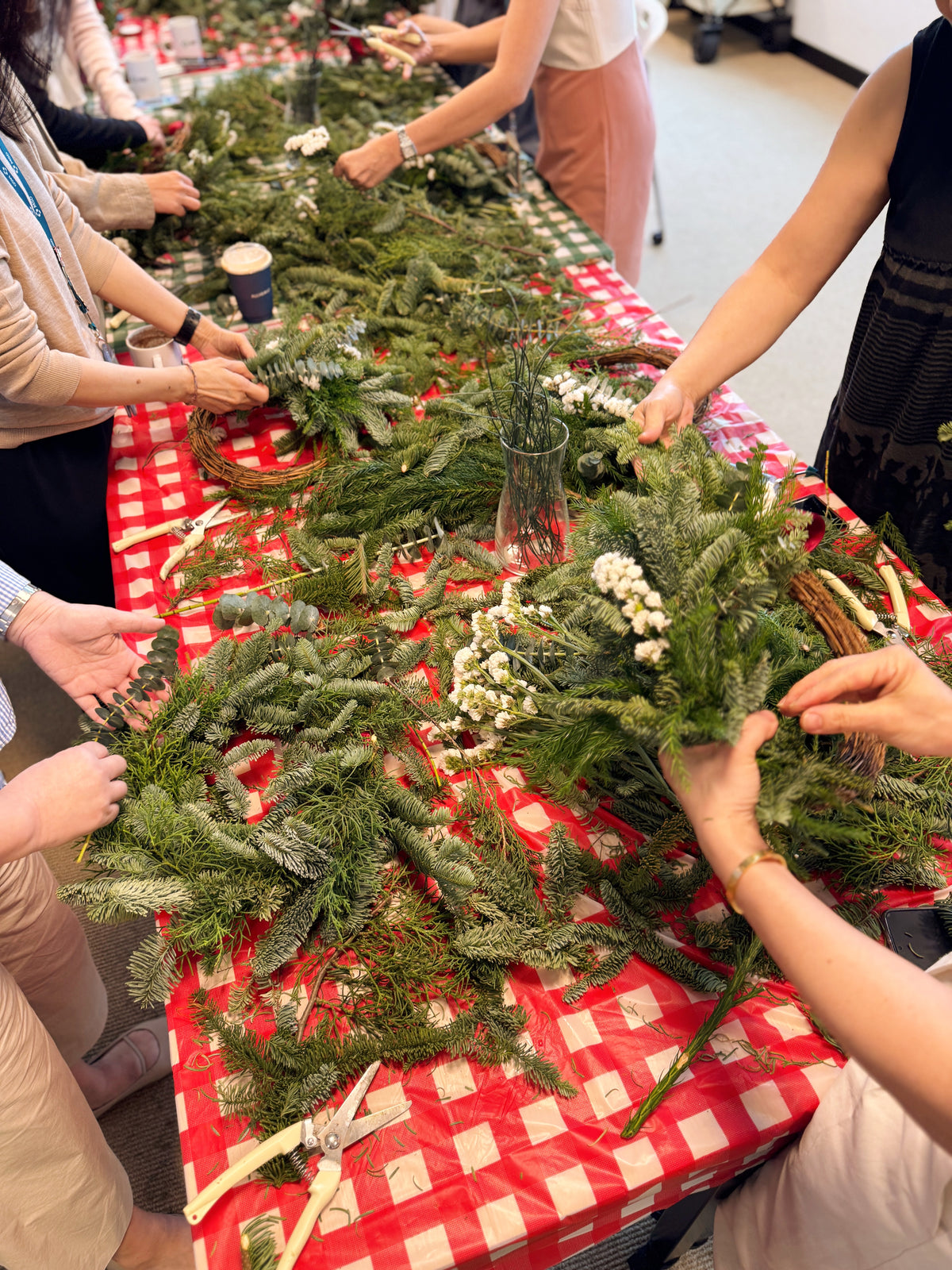 People working on Christmas wreaths, b2b team bonding workshop by Eden's Ground.
