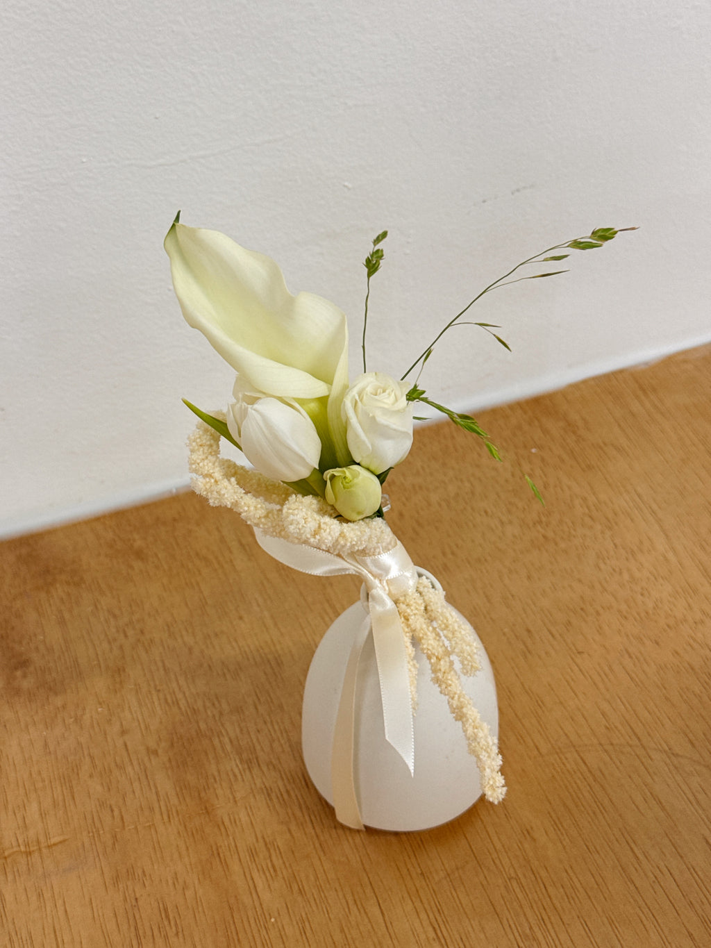Bespoke Boutonniere matching white elegant calla lilies bridal bouquet.
