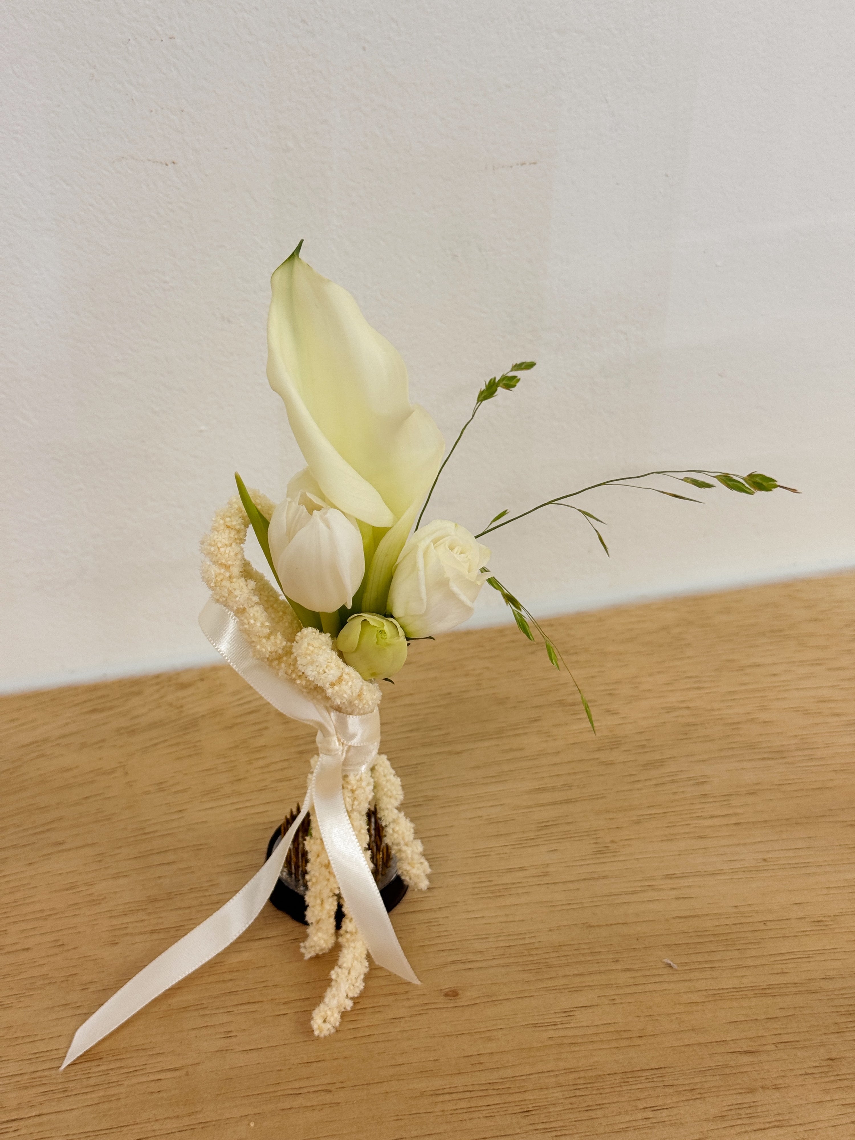 Bespoke Boutonniere matching white elegant calla lilies bridal bouquet.