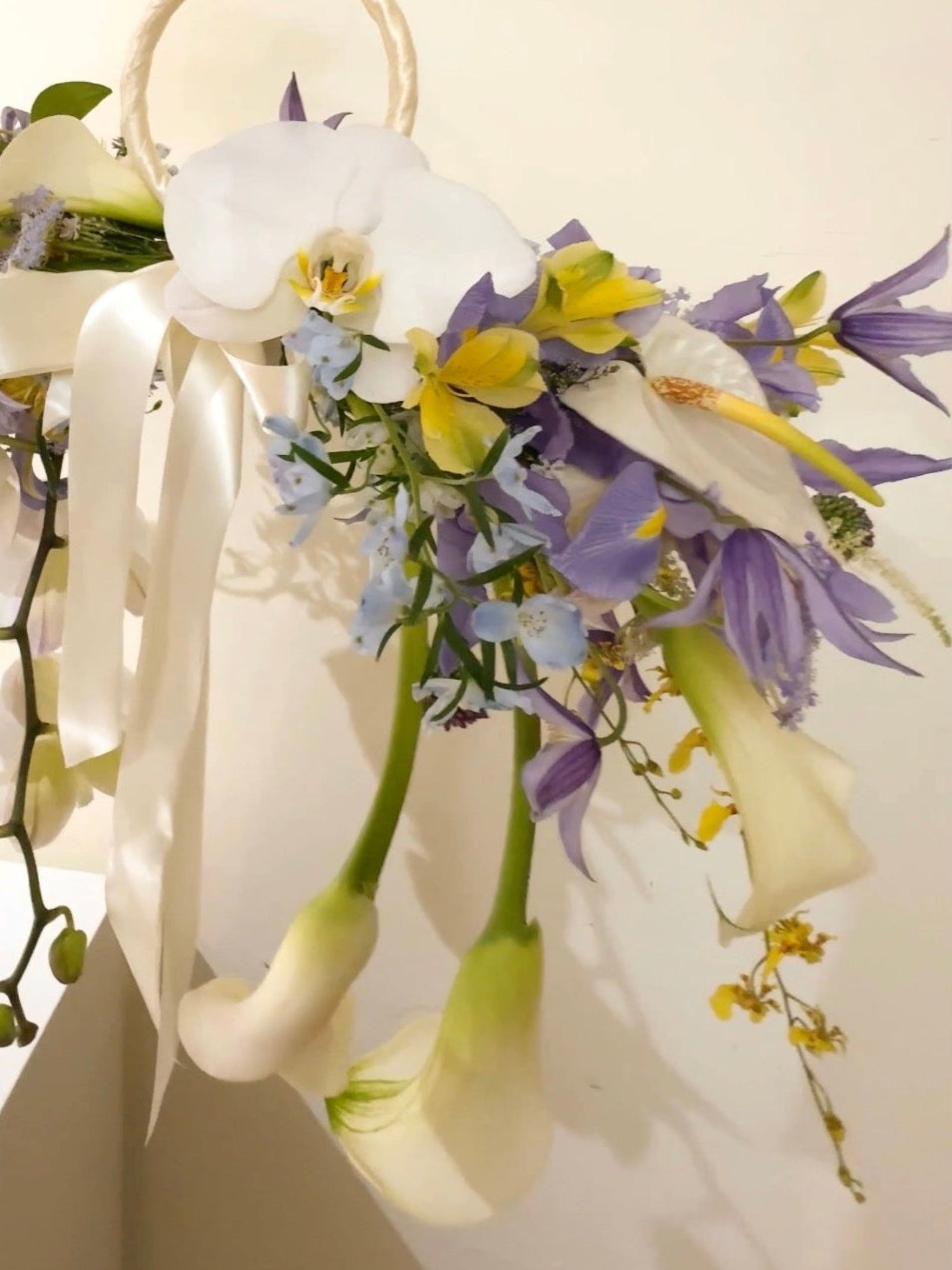 2026 Bridal Bouquet and Wedding Trend. Custom Bridal Bouquet Bag made with white Calla Lilies and Orchid, crafted by Eden's Ground.