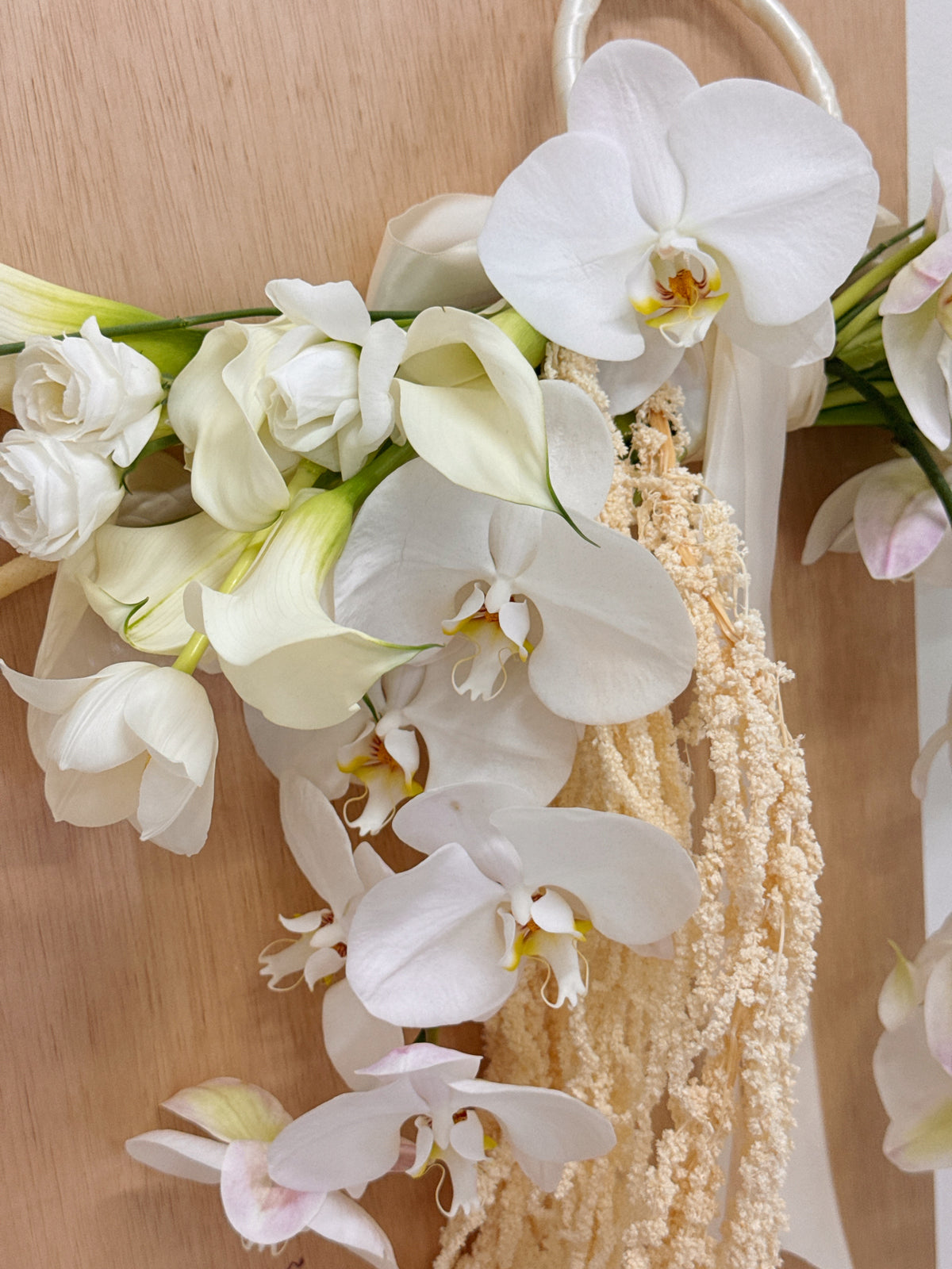 Top 2026 Bridal Bouquet and Wedding Trend. Custom Bridal Bouquet Bag made with white Calla Lilies and Orchid, crafted by Eden's Ground.