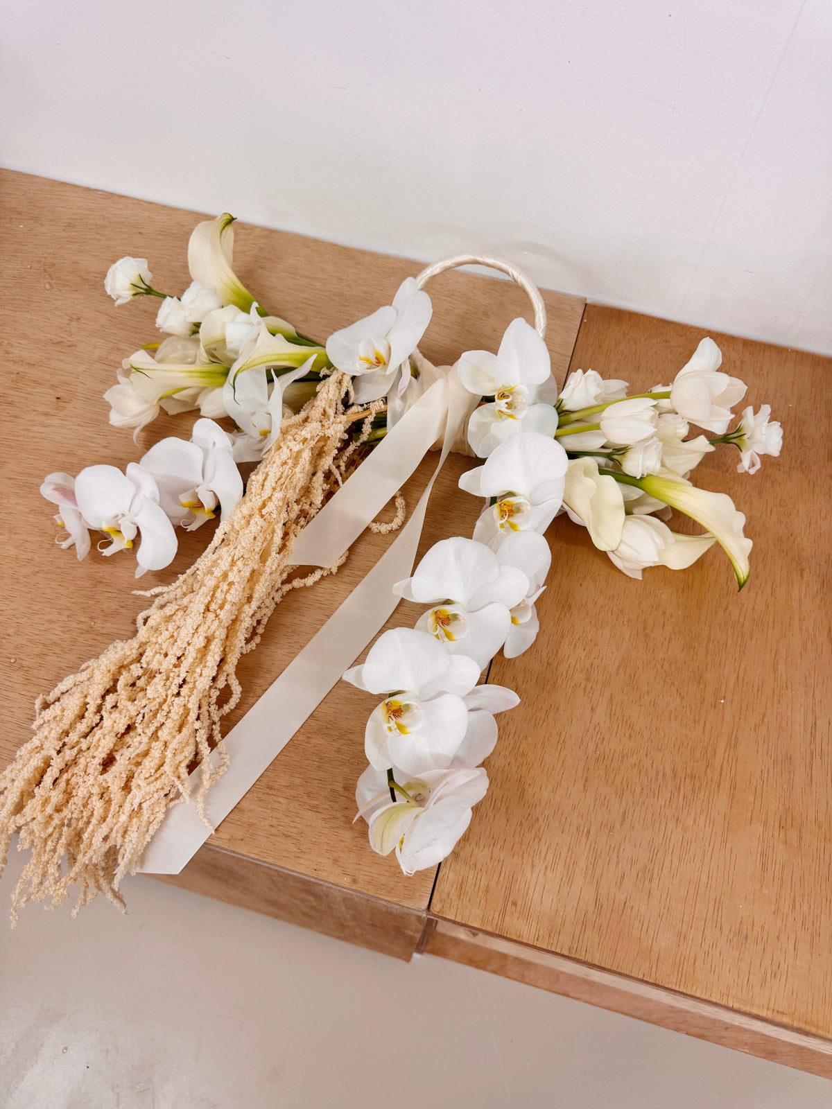 Top 2026 2027 Bridal Bouquet and Wedding Trend. Custom Bridal Bouquet Bag made with white Calla Lilies and Orchid, crafted by Eden's Ground.