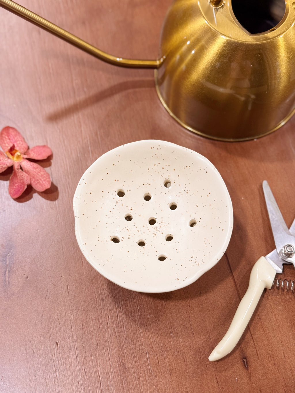 White ceramic Ikebana Japanese inspired potting tool with holes for floral arranging.