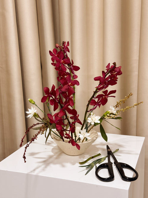 White ceramic Ikebana Japanese inspired potting tool with holes for floral arranging.