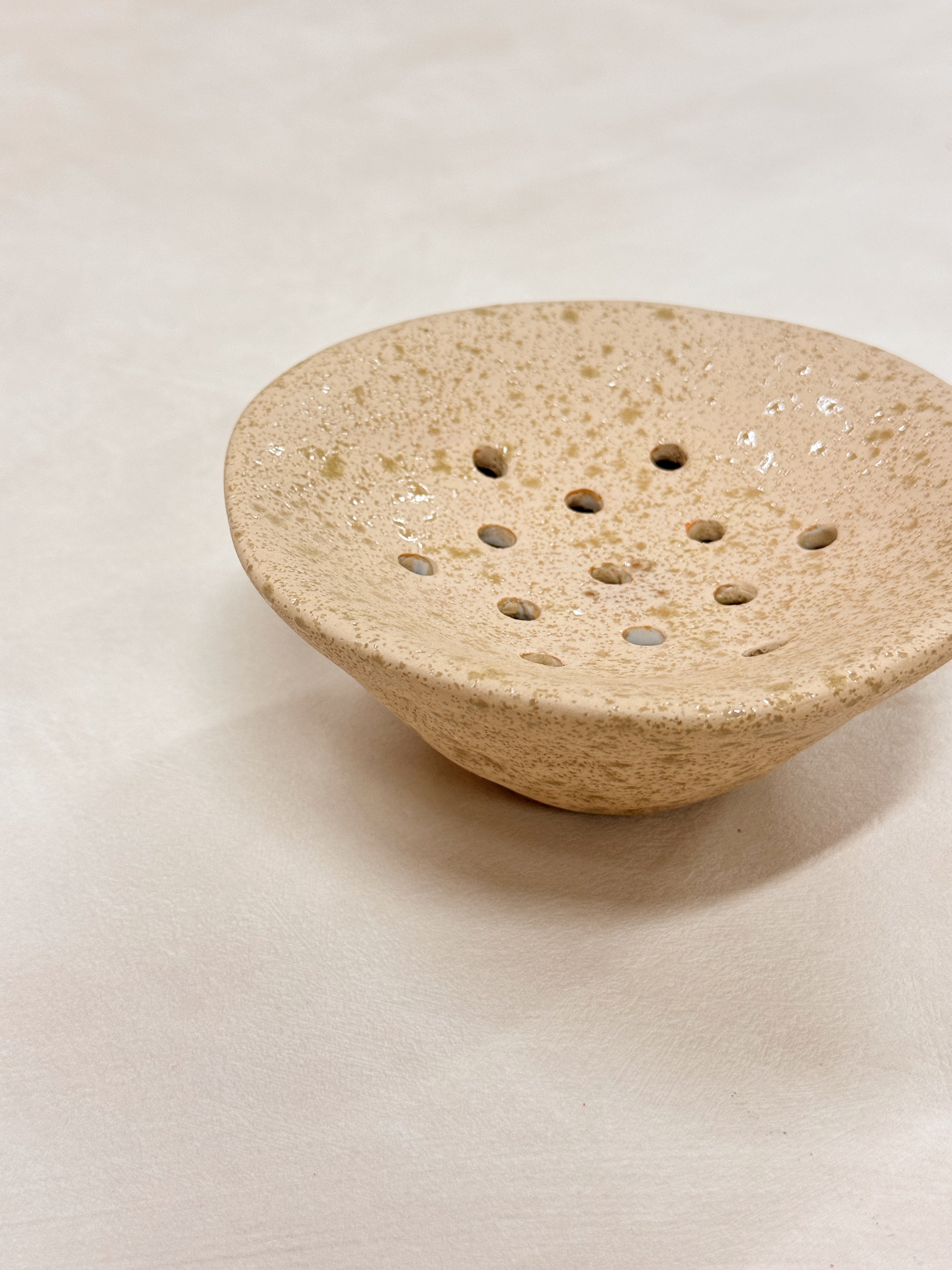 White ceramic Ikebana Japanese inspired potting tool with holes for floral arranging.