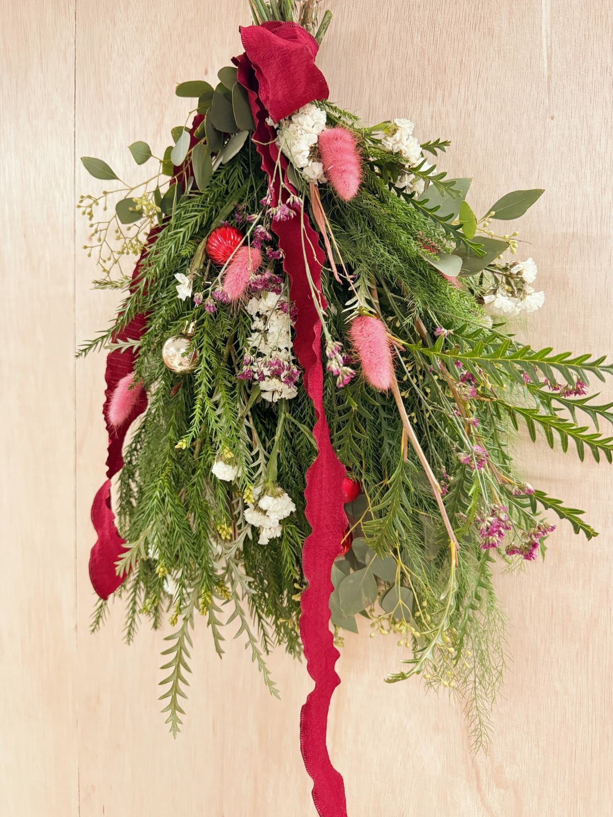 A Christmas swag Workshop in Singapore by Eden's Ground. Create your own festive decorative door swag arrangement using a variety of fresh firs, pine, foliage like eucalyptus, and natural textures and flowers. Held at our cosy floral studio in Tai Seng, it's the perfect hands-on holiday experience to get into the Christmas spirit.