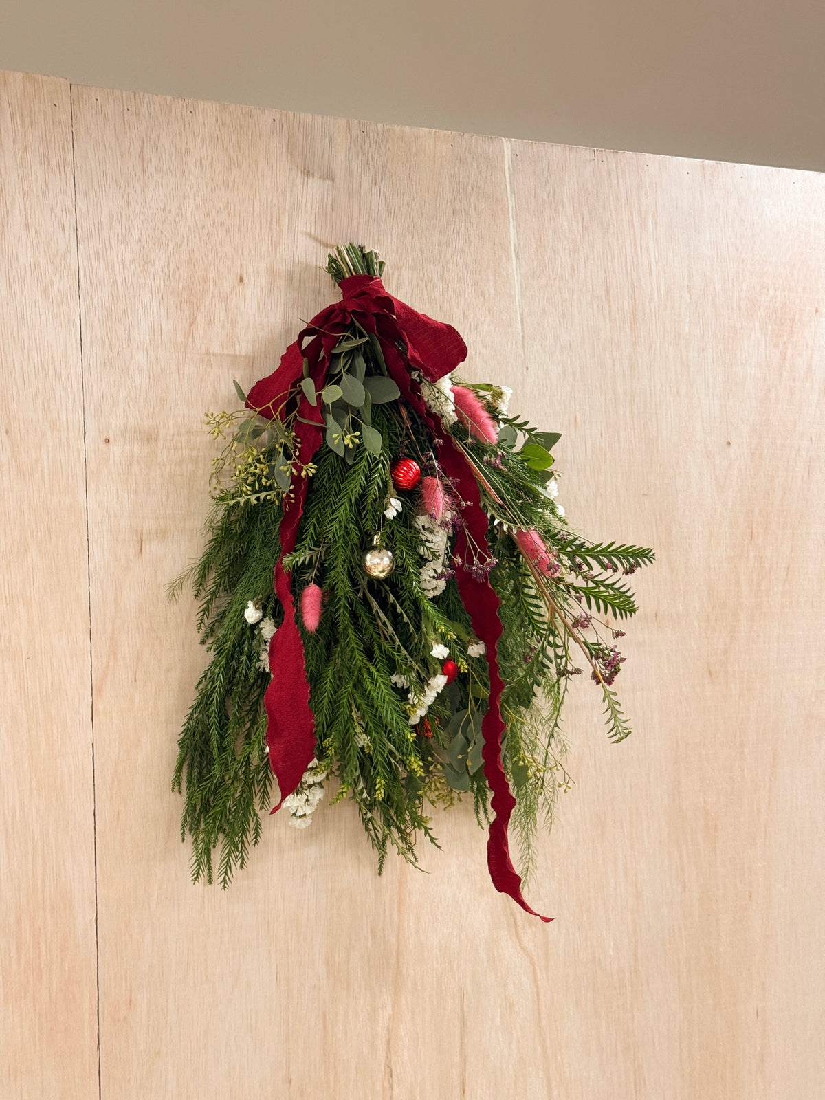 A Christmas swag Workshop in Singapore by Eden's Ground. Create your own festive decorative door swag arrangement using a variety of fresh firs, pine, foliage like eucalyptus, and natural textures and flowers. Held at our cosy floral studio in Tai Seng, it's the perfect hands-on holiday experience to get into the Christmas spirit.