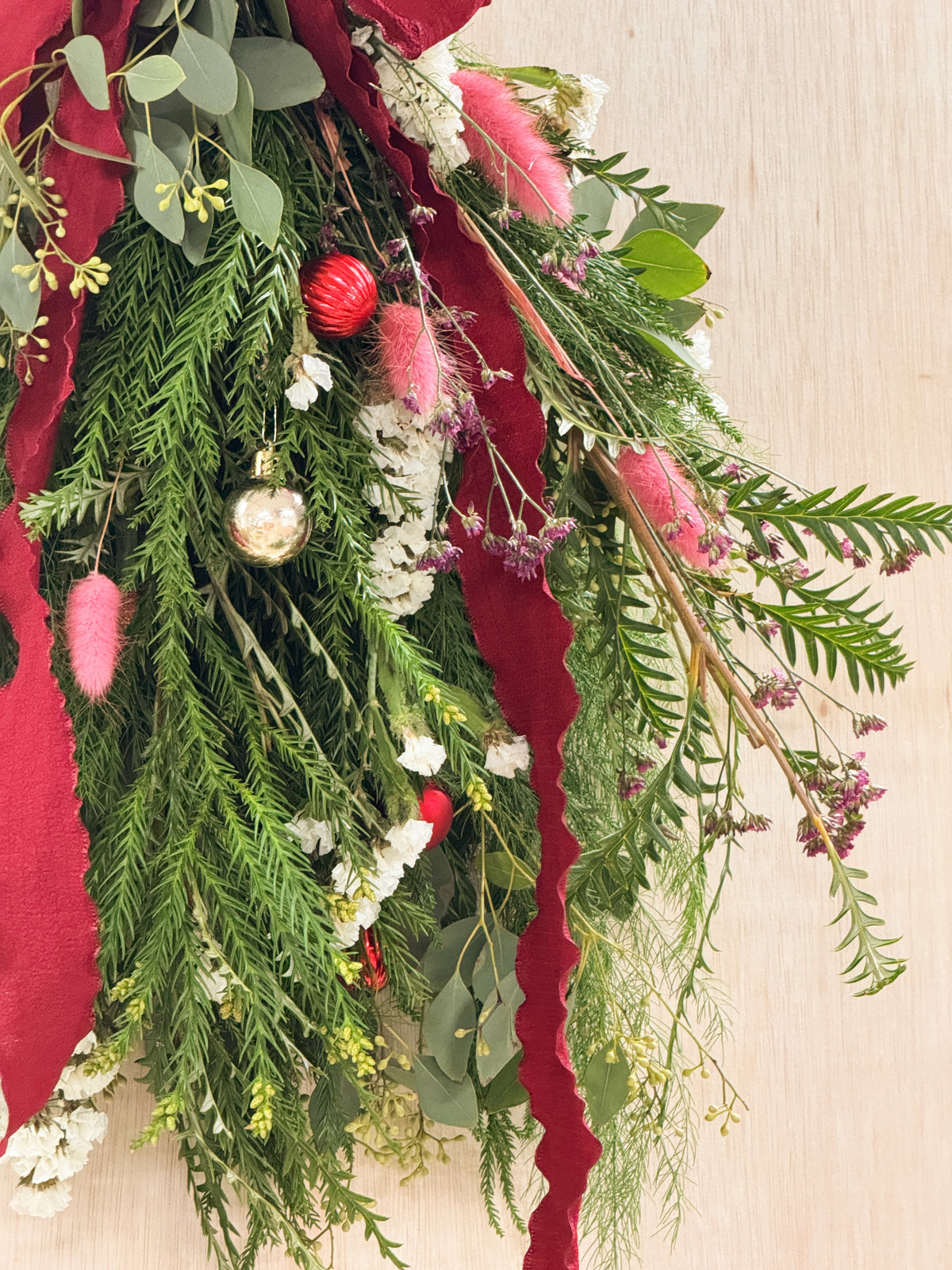 A Christmas swag Workshop in Singapore by Eden's Ground. Create your own festive decorative door swag arrangement using a variety of fresh firs, pine, foliage like eucalyptus, and natural textures and flowers. Held at our cosy floral studio in Tai Seng, it's the perfect hands-on holiday experience to get into the Christmas spirit.