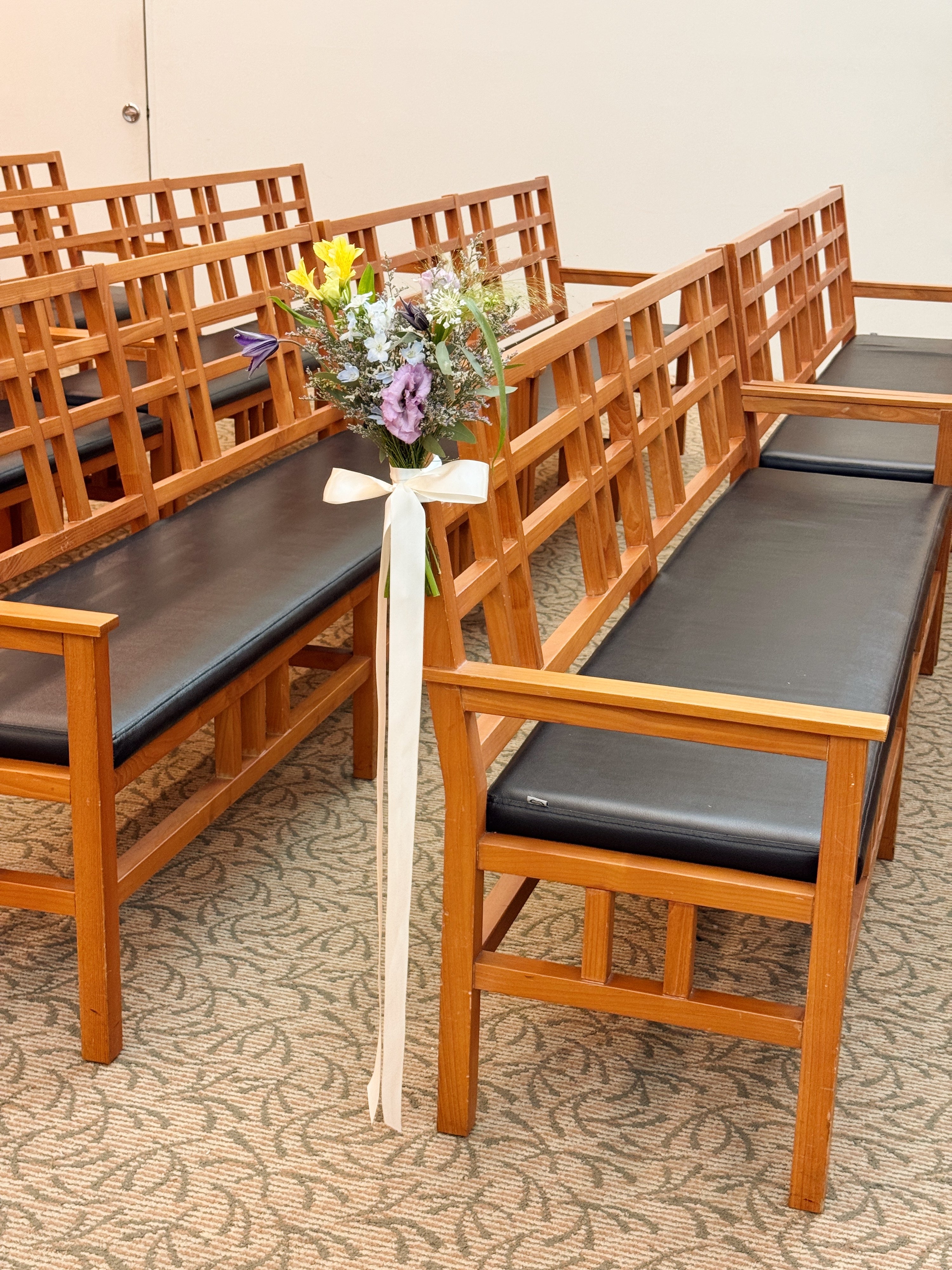 Church aisle pew flowers, craffted with fresh flowers by Eden's Ground, a floral design boutique.