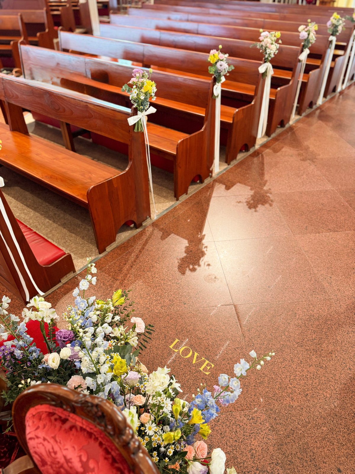 Church aisle pew flowers, craffted with fresh flowers by Eden's Ground, a floral design boutique.