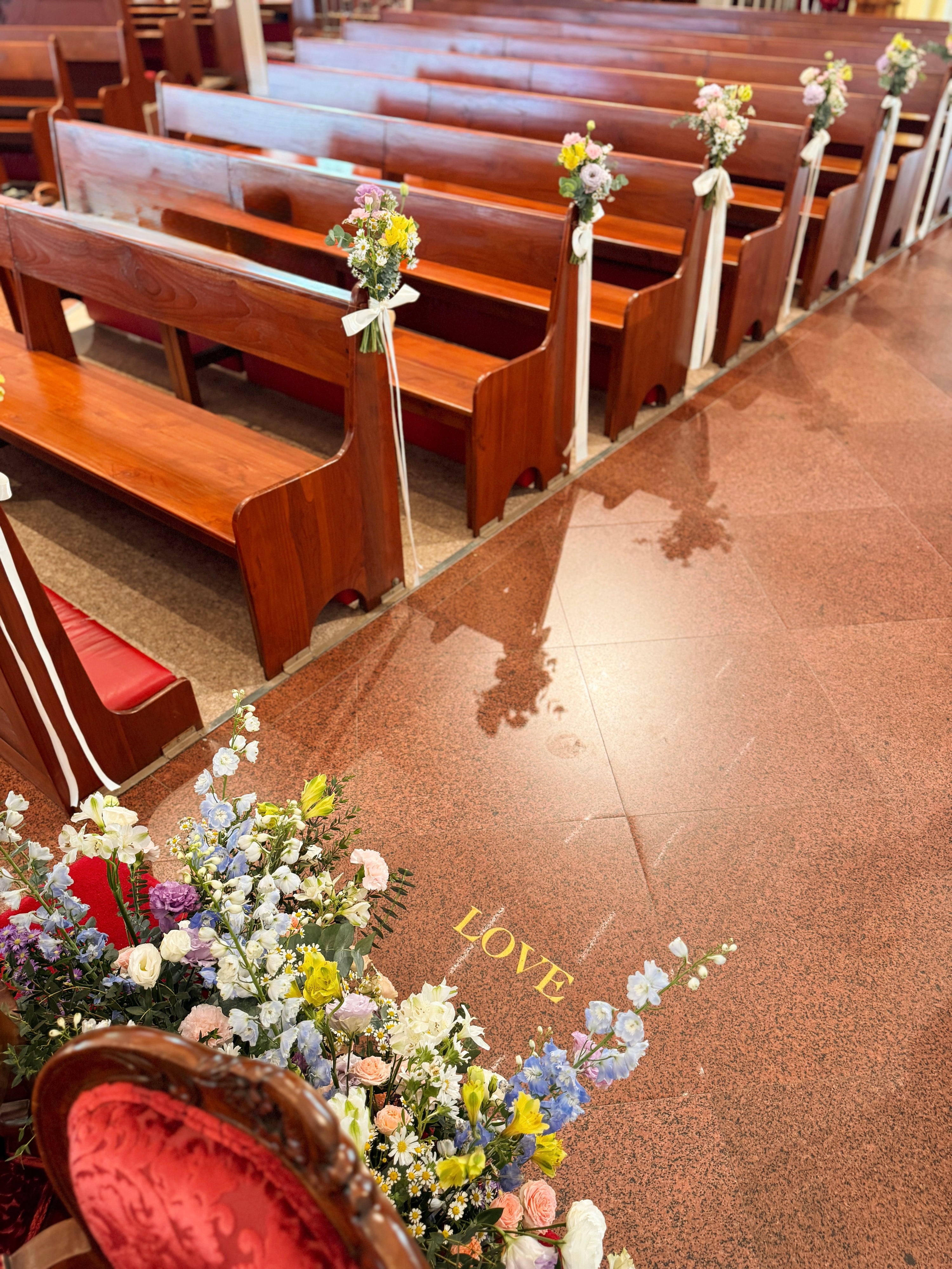 Church aisle pew flowers, craffted with fresh flowers by Eden's Ground, a floral design boutique.