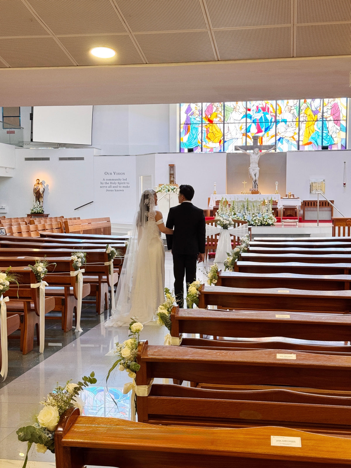 Church aisle pew flowers, craffted with fresh flowers by Eden's Ground, a floral design boutique.