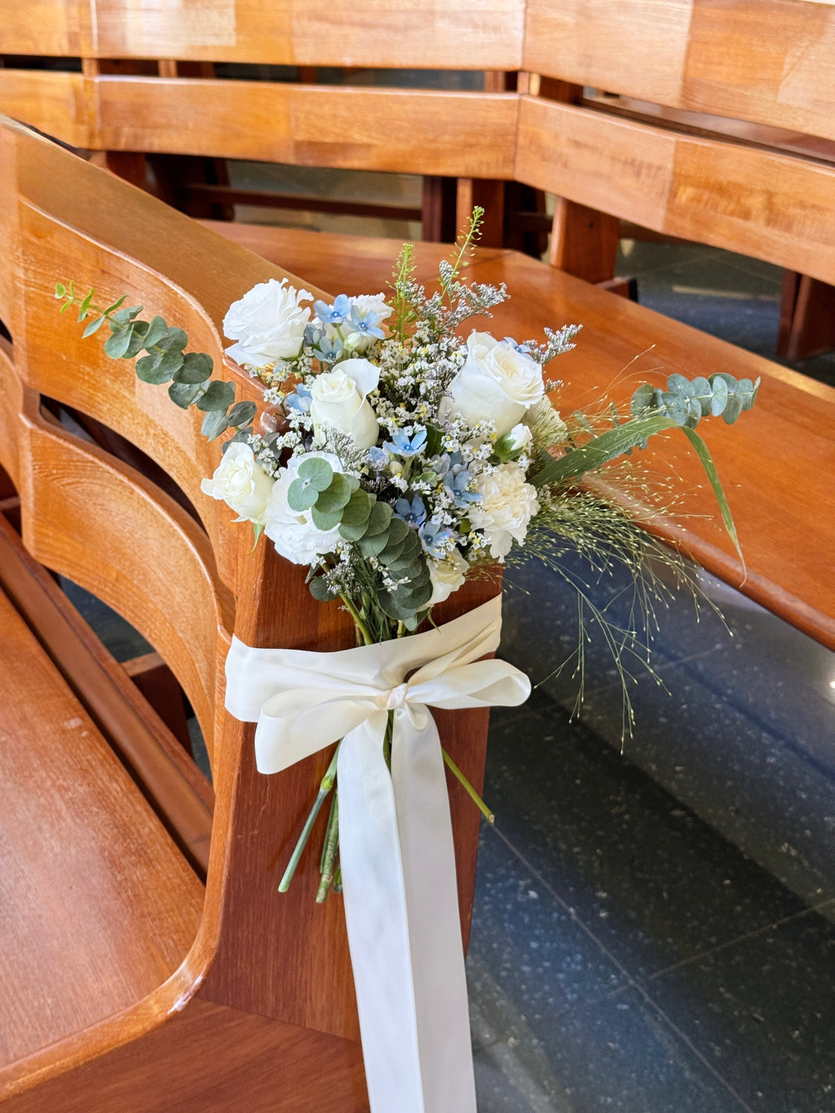Church aisle pew flowers, craffted with fresh flowers by Eden's Ground, a floral design boutique.