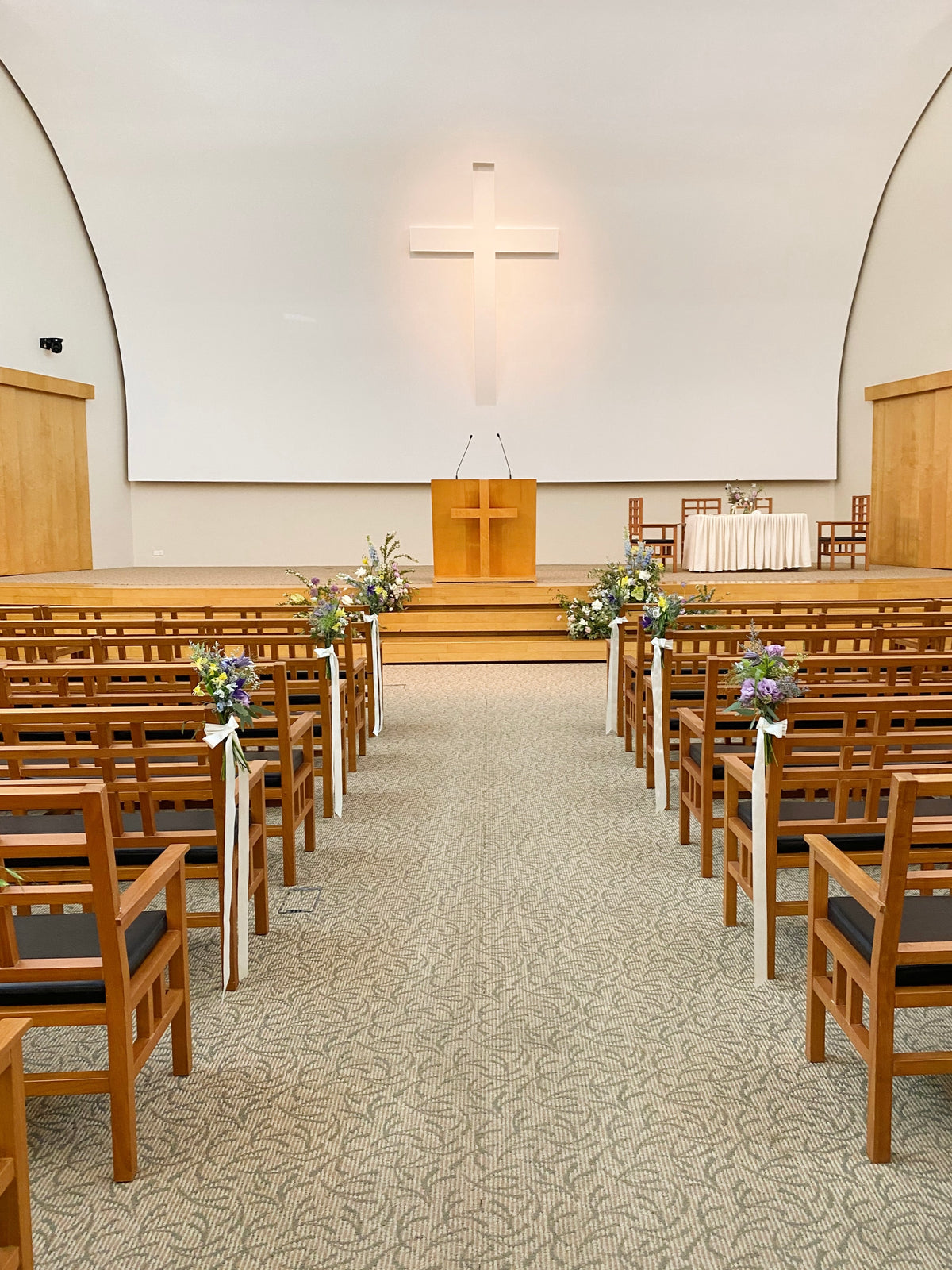 Church aisle pew flowers, craffted with fresh flowers by Eden's Ground, a floral design boutique.