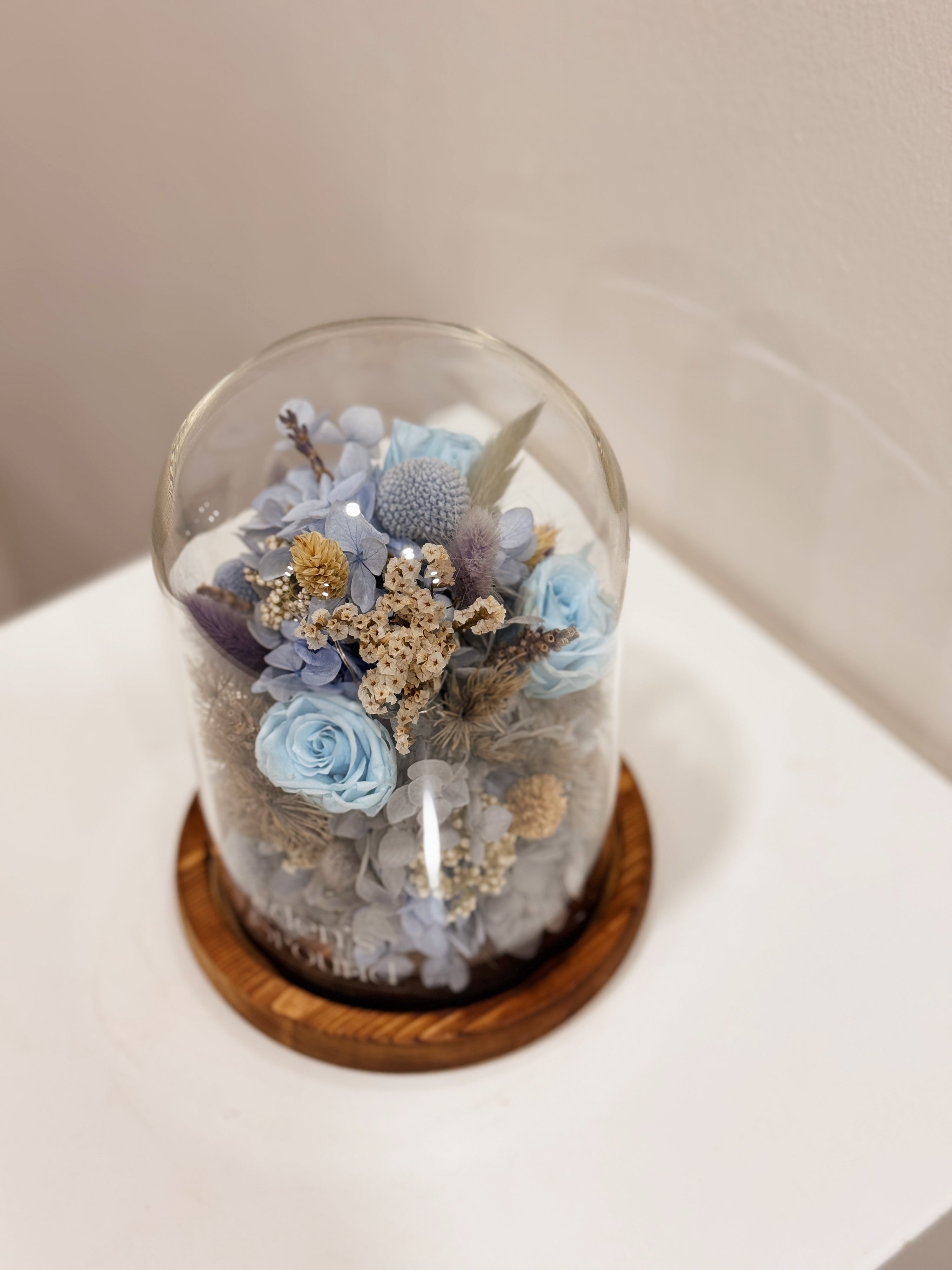 Cloud Garden Preserved Flower Dome is made with a delicate blend of preserved and dried flowers in shades of blue, beautifully arranged in a glass dome by Eden’s Ground—an unforgettable gift or home decor made to last. 