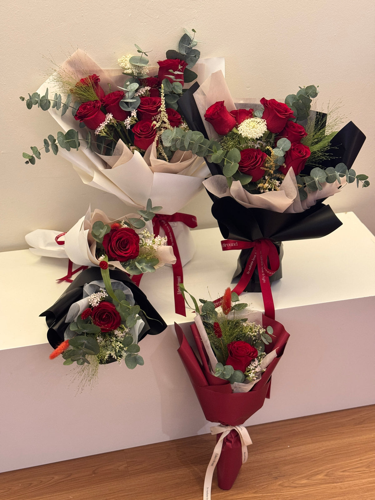 Crimson Garden red roses bouquet wrapped in white, red, or black glassine paper crafted by Eden’s Ground. A classic Valentine's day bouquet.