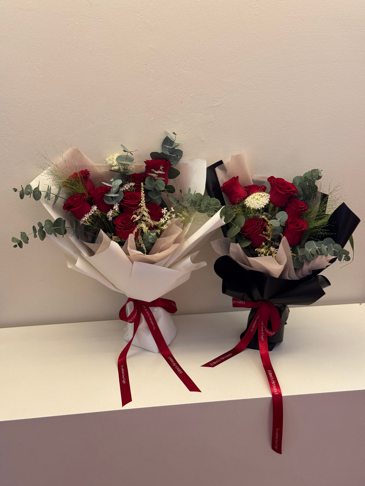 Crimson Garden red roses bouquet wrapped in white, red, or black glassine paper crafted by Eden’s Ground. A classic Valentine's day bouquet.