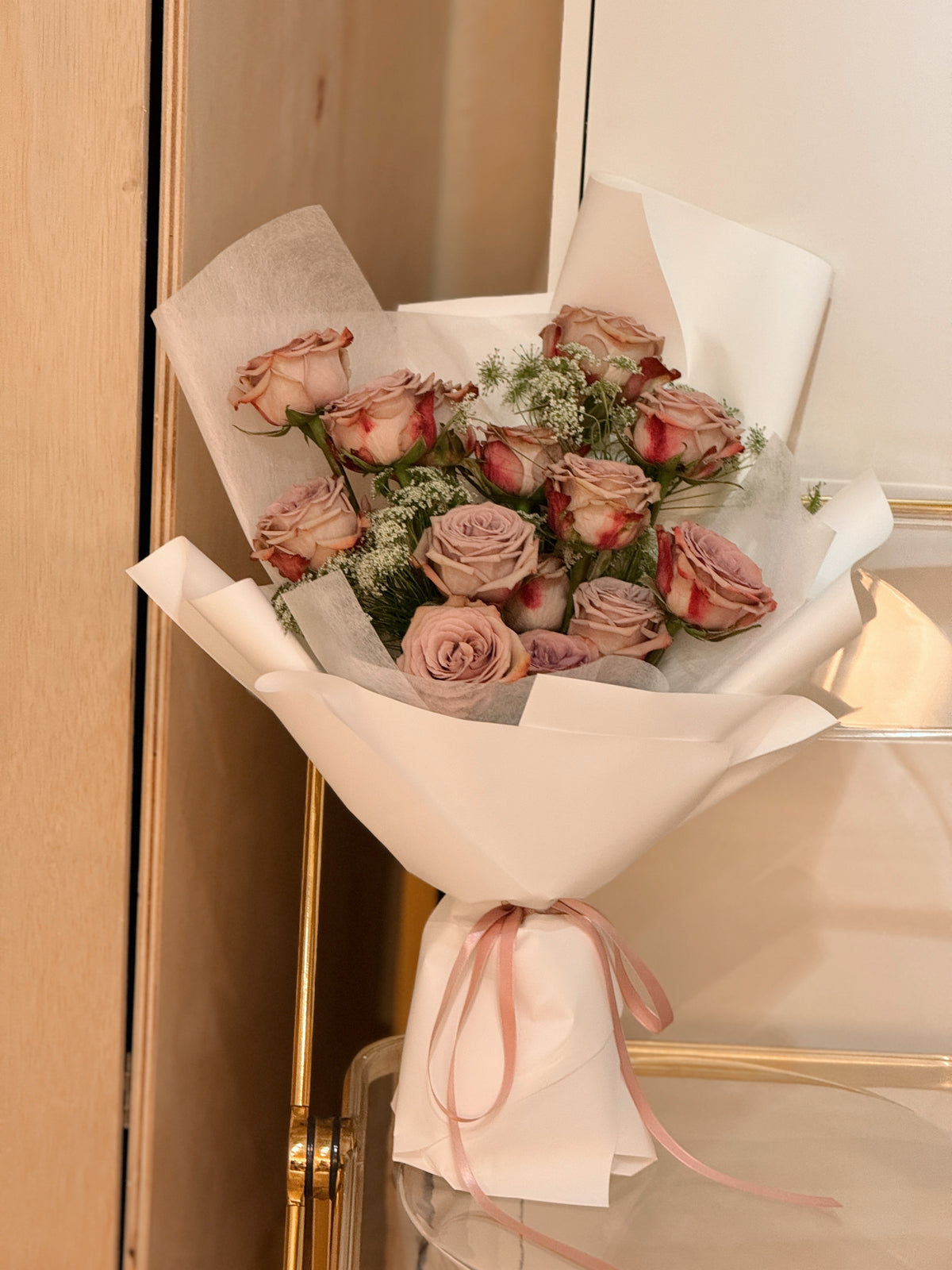 Crimson and clover bouquet cappuccino rose bouquet meticulously selected for its petals that exude opulence and elegance, along with delicate lace flowers, wrapped in white tissue and glassine paper crafted by Eden's Ground. 