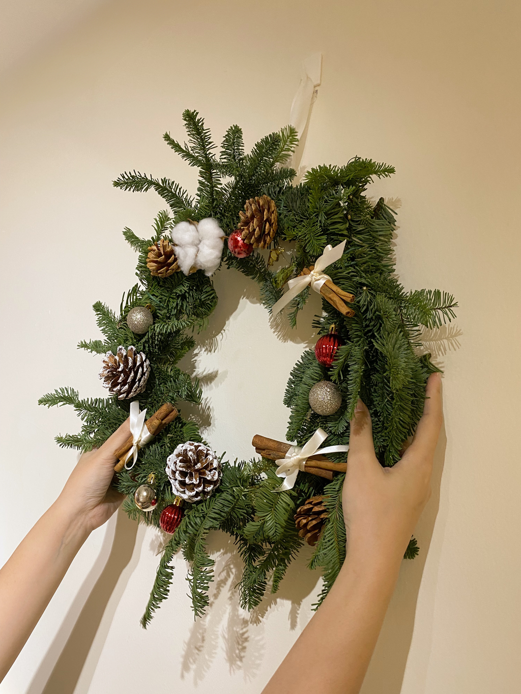 Fresh DIY Kit Christmas Wreath, decorated with baubles, ornaments, cotton, pinecones, cinnamon sticks and more by Eden's Ground, a Floral Design Studio in Singapore.
