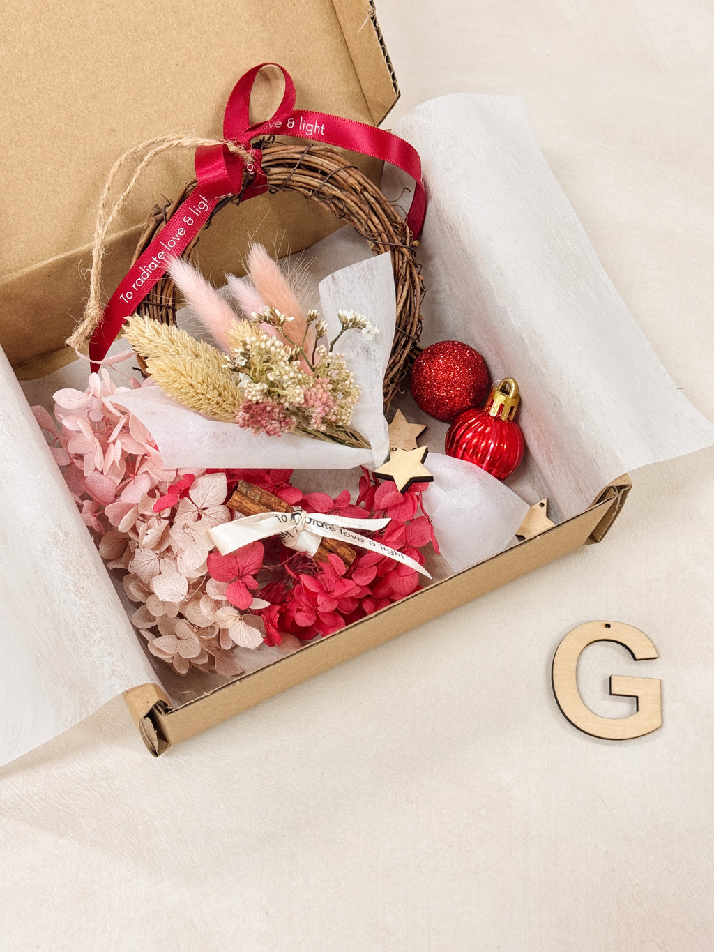 Preserved and Dried DIY Kit Christmas Wreath, decorated with baubles, ornaments, cinnamon sticks, hydrangeas and more by Eden's Ground, a Floral Design Studio in Singapore.