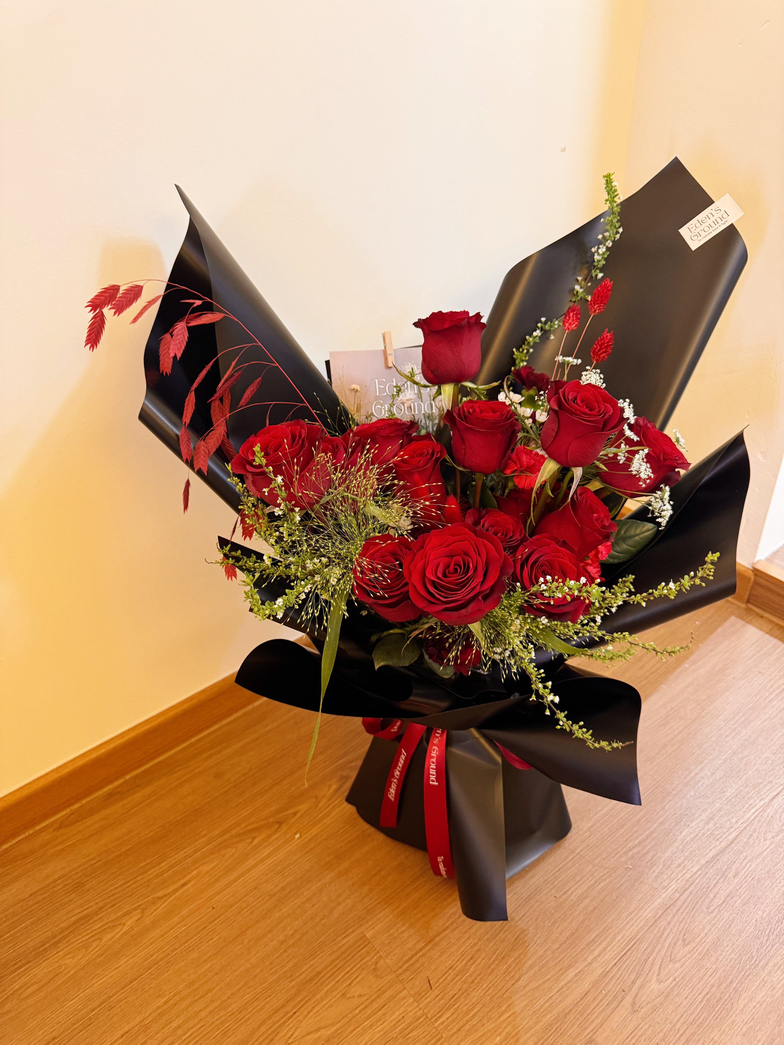 Classic Red Roses Korean-Style Bouquet, wrapped in black paper crafted by Eden’s Ground.