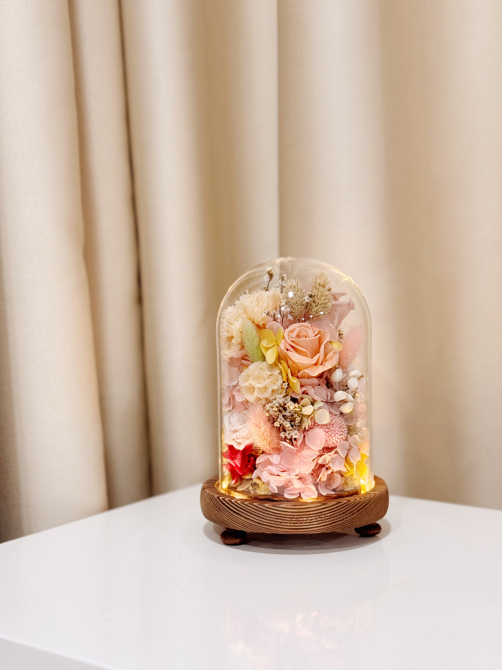 Ethereal Embrace Flower Dome is made with a delicate blend of preserved and dried flowers in a variety of vibrant colours, beautifully arranged in a glass dome by Eden’s Ground—an unforgettable gift or home decor made to last. 