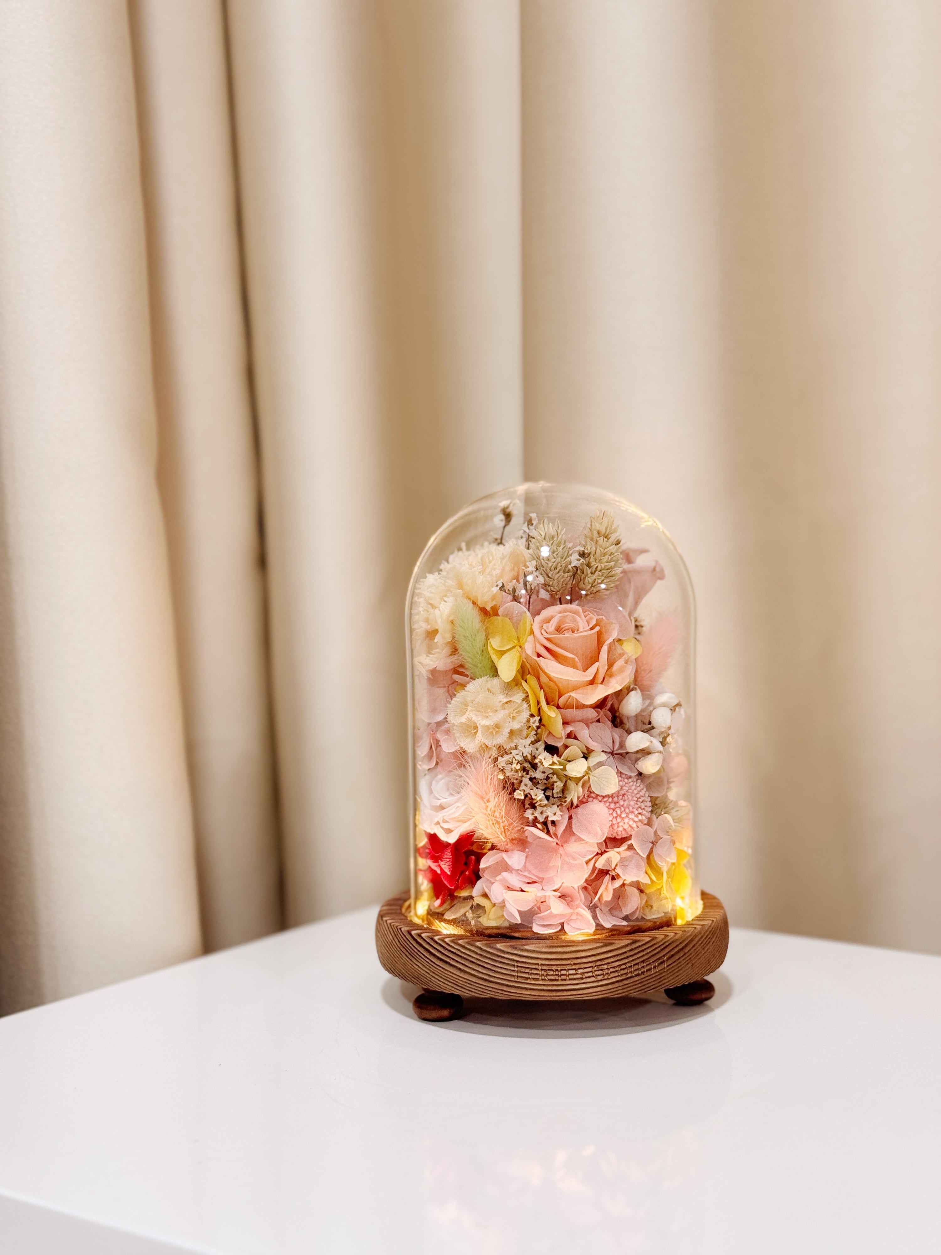 Ethereal Embrace Flower Dome is made with a delicate blend of preserved and dried flowers in a variety of vibrant colours, beautifully arranged in a glass dome by Eden’s Ground—an unforgettable gift or home decor made to last. 