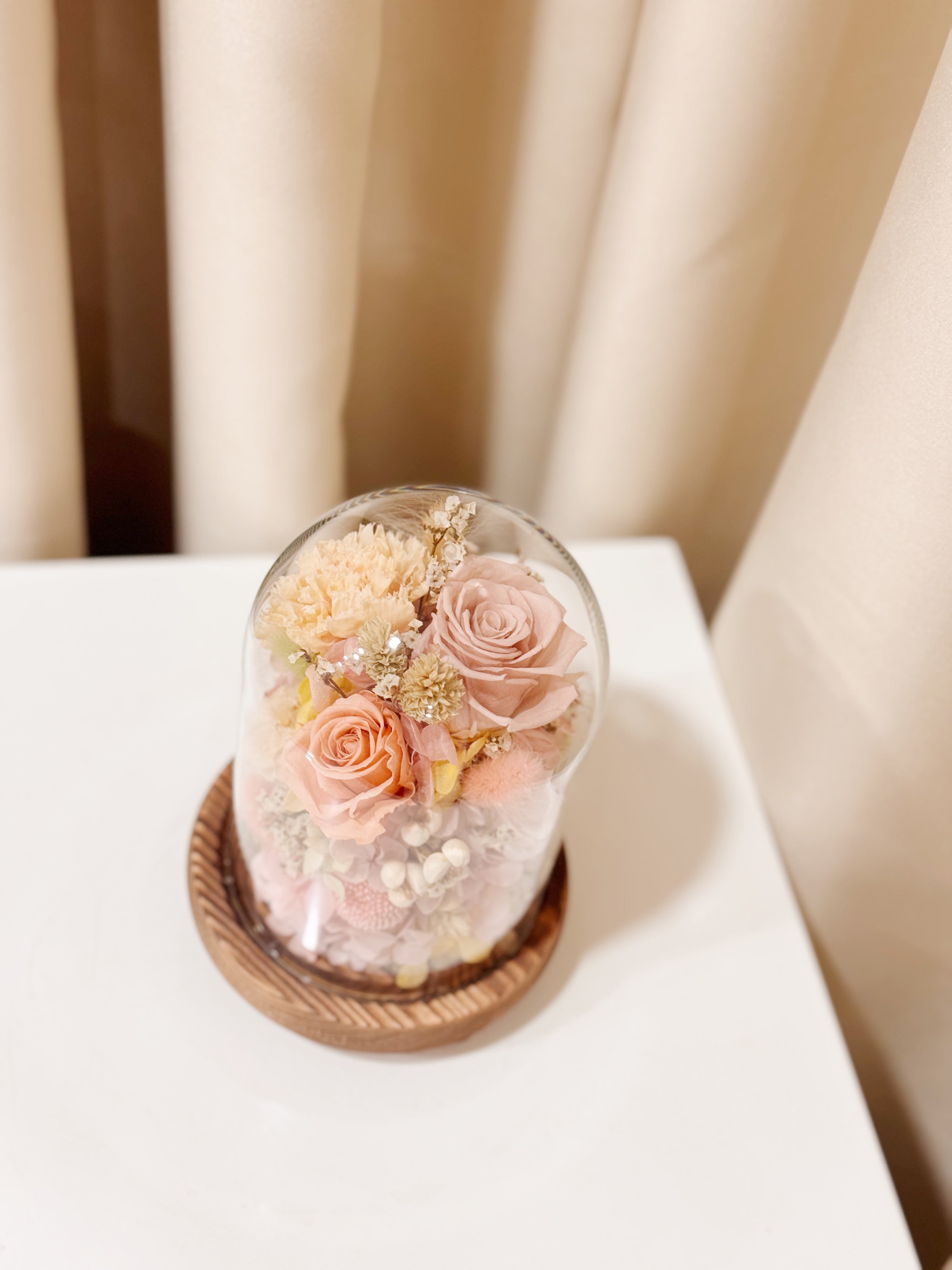 Ethereal Embrace Flower Dome is made with a delicate blend of preserved and dried flowers in a variety of vibrant colours, beautifully arranged in a glass dome by Eden’s Ground—an unforgettable gift or home decor made to last. 