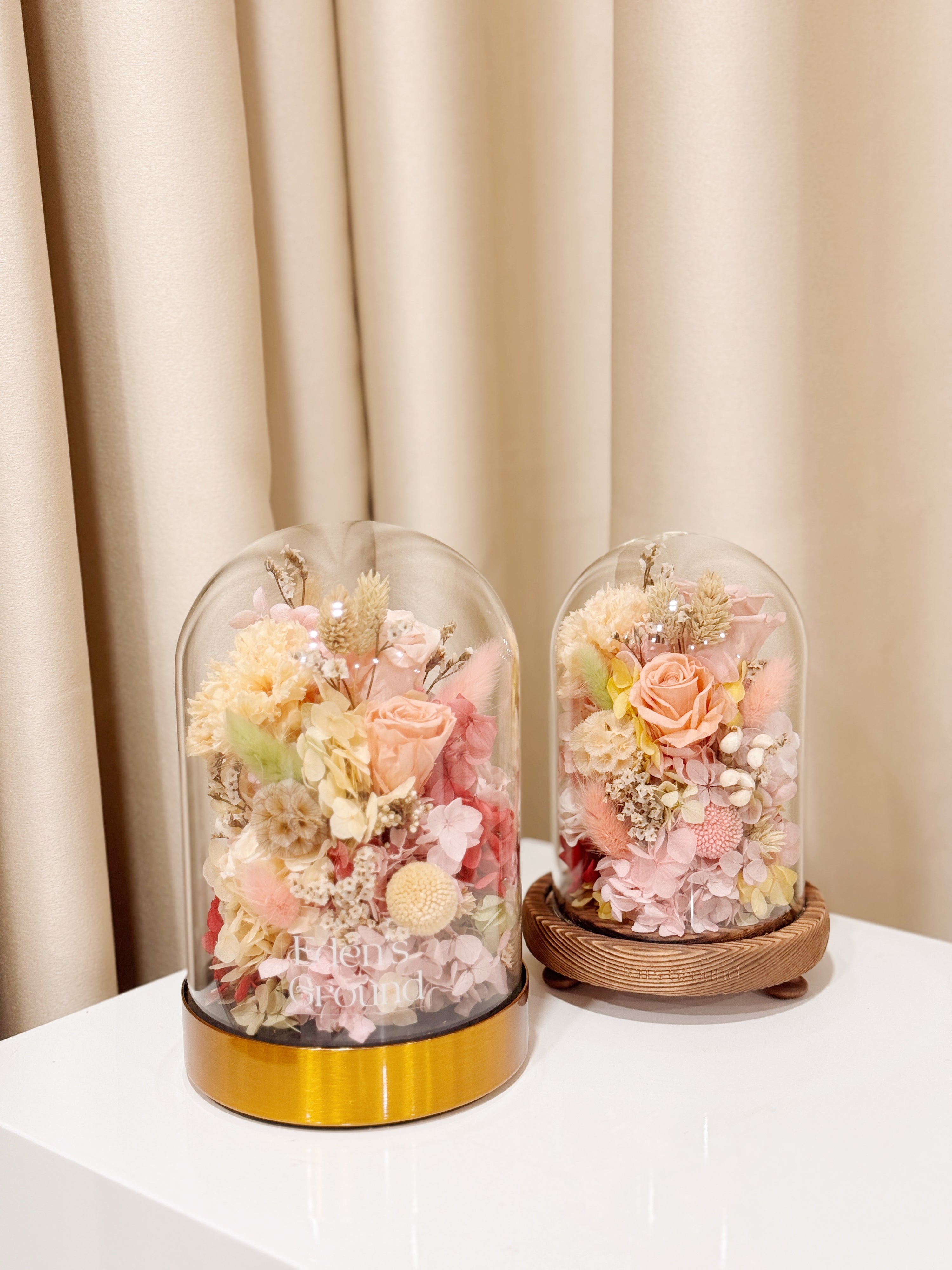 Ethereal Embrace Flower Dome is made with a delicate blend of preserved and dried flowers in a variety of vibrant colours, beautifully arranged in a glass dome by Eden’s Ground—an unforgettable gift or home decor made to last. 