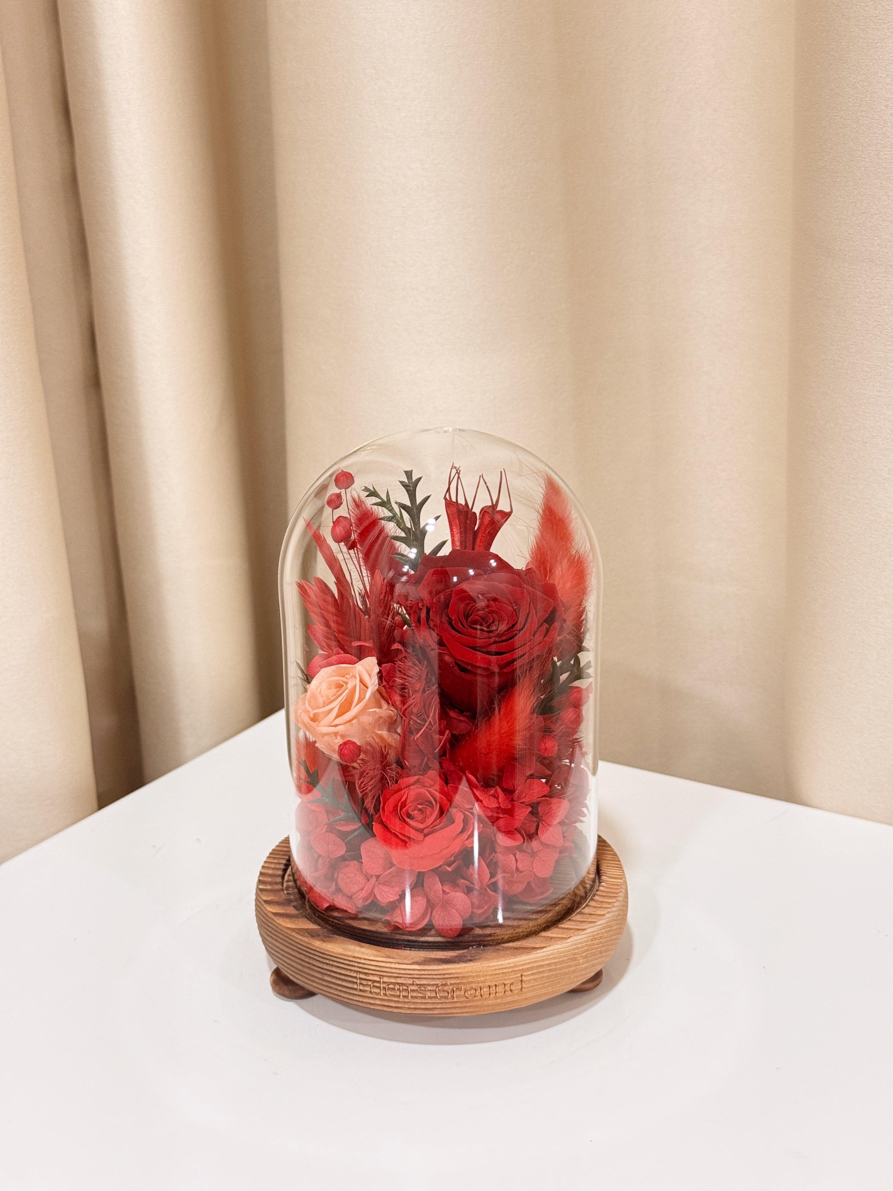 Everlasting Love Flower Dome is made with a delicate blend of preserved red roses, and flowers in a variety of soft pastel colours, beautifully arranged in a glass dome by Eden’s Ground—an unforgettable gift or home decor made to last. 