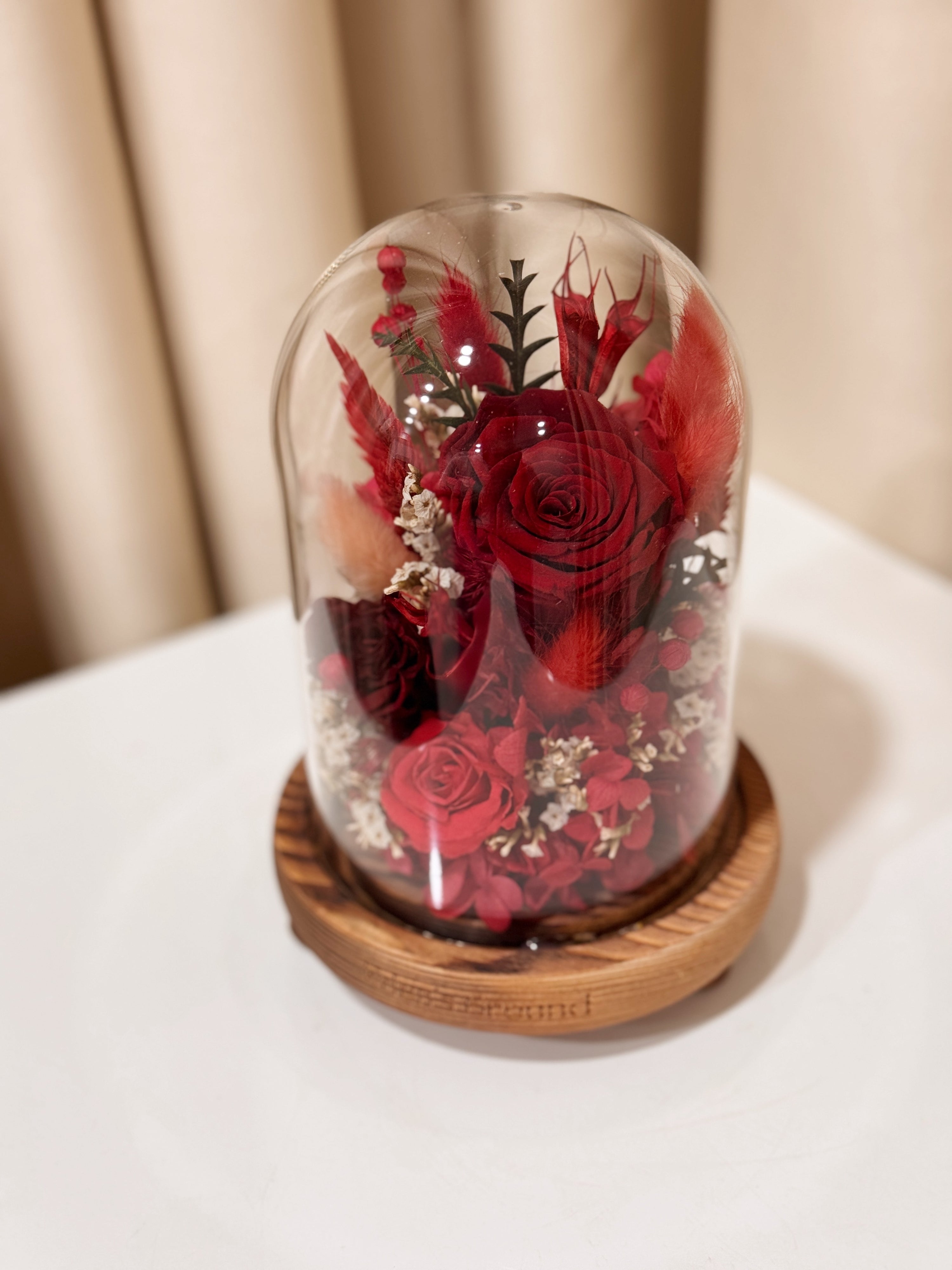 Everlasting Love Flower Dome is made with a delicate blend of preserved red roses, and flowers in a variety of soft pastel colours, beautifully arranged in a glass dome by Eden’s Ground—an unforgettable gift or home decor made to last. 