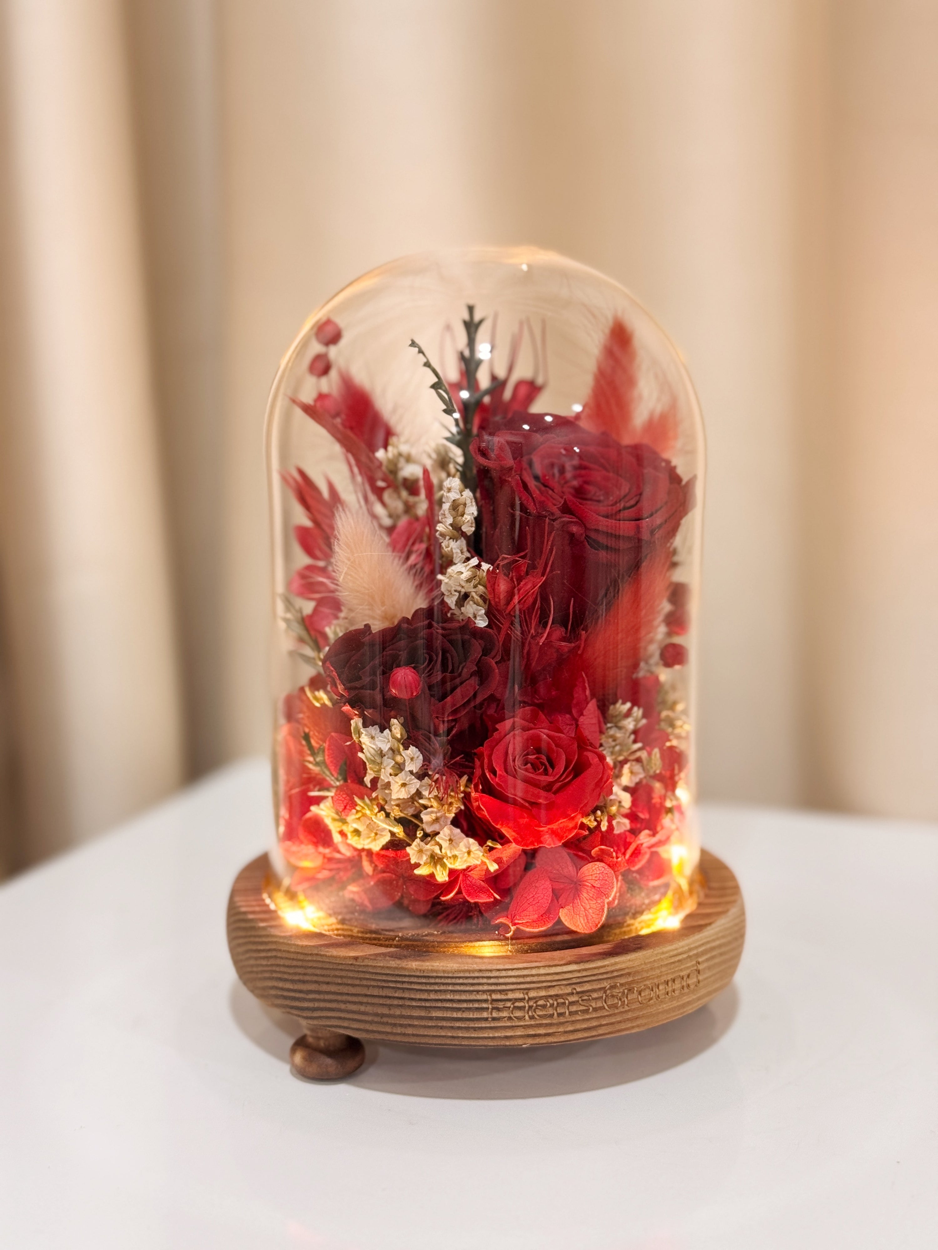 Everlasting Love Flower Dome is made with a delicate blend of preserved red roses, and flowers in a variety of soft pastel colours, beautifully arranged in a glass dome by Eden’s Ground—an unforgettable gift or home decor made to last. 