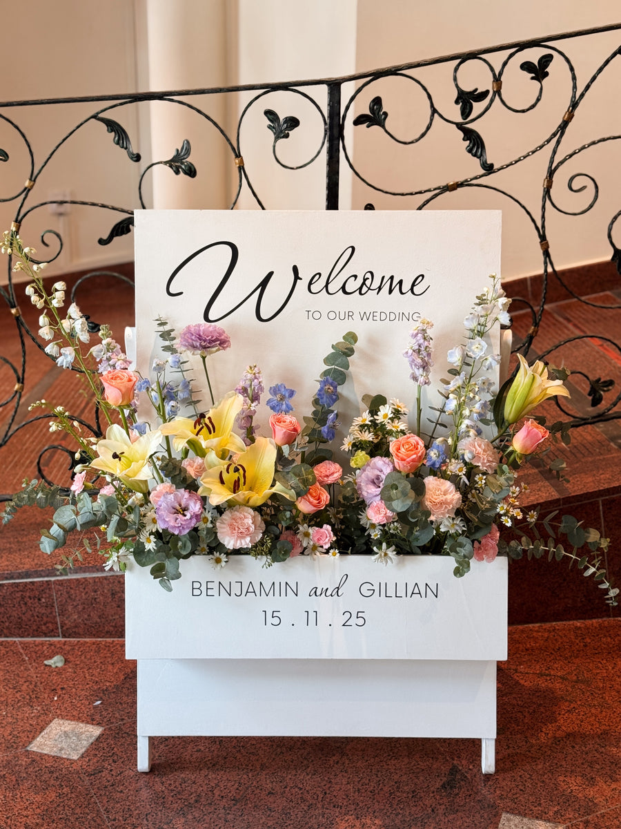 Elegant customisable welcome sign with flower box to welcome guests entering your wedding or birthday party venue in Singapore, rental by Eden's Ground.