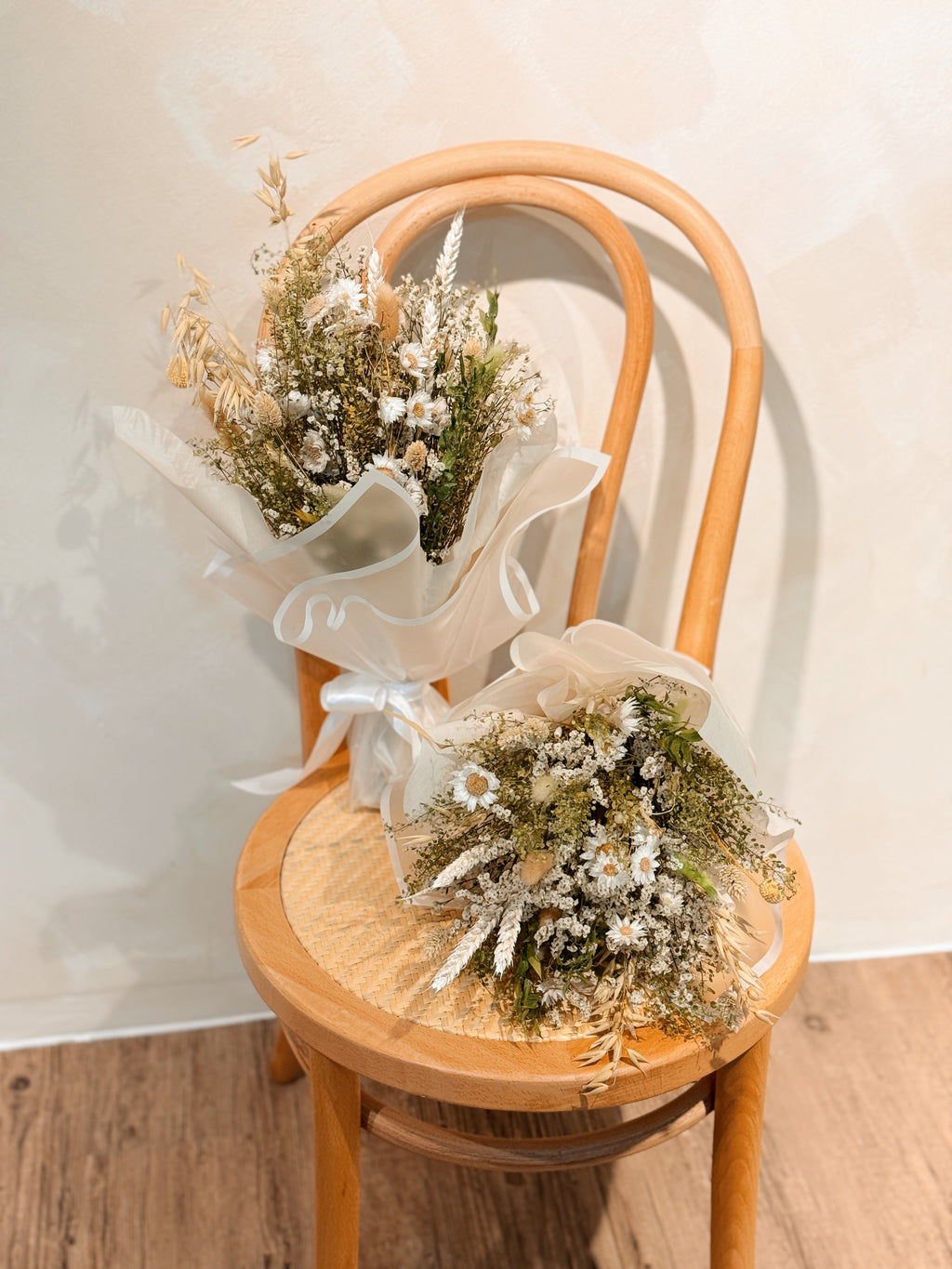 Forest nymph dried flower bouquet made of earth-toned, nature-inspired wildflowers, featuring delicate chamomile daisy and textural foliage, wrapped in glassine paper crafted by Eden’s Ground.