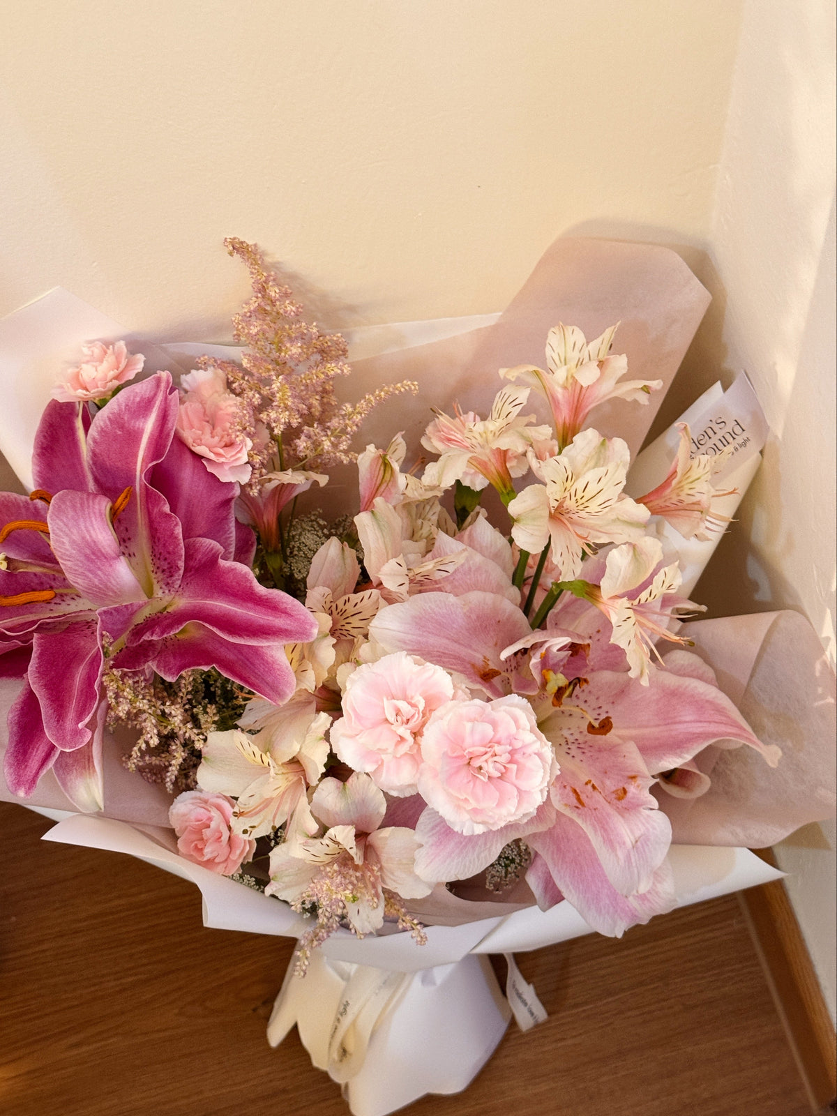 Grace In Bloom featuring beautiful pink rose lily, alstroemeria lilies and carnation, wrapped in tissue paper and white glassing paper crafted by Eden’s Ground.