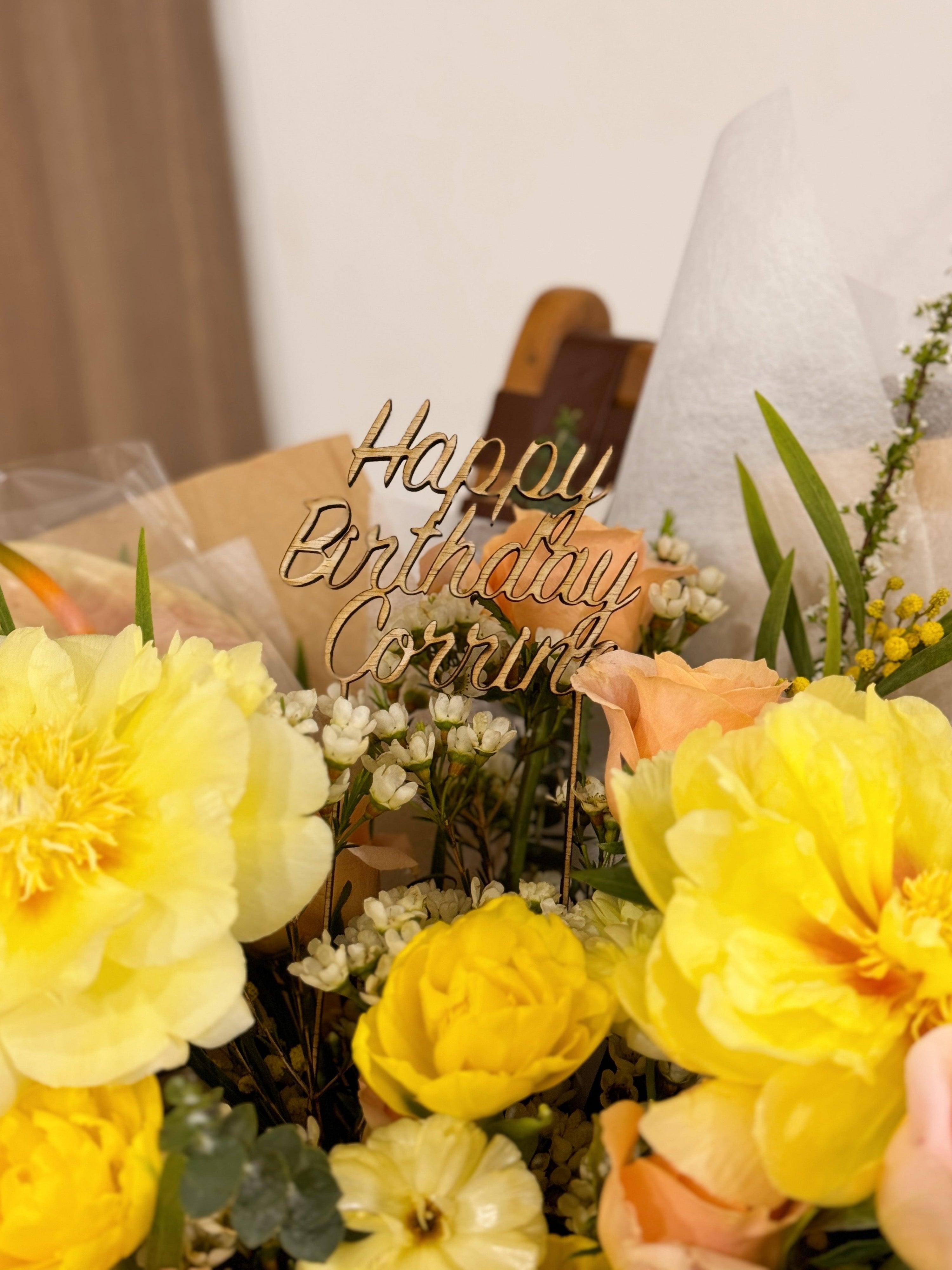 Luxurious premium yellow peony bouquet featuring peonies, roses, along with filler flowers and foliage like eucalyptus, wrapped in tissue paper and brown kraft paper, crafted by Eden's Ground.