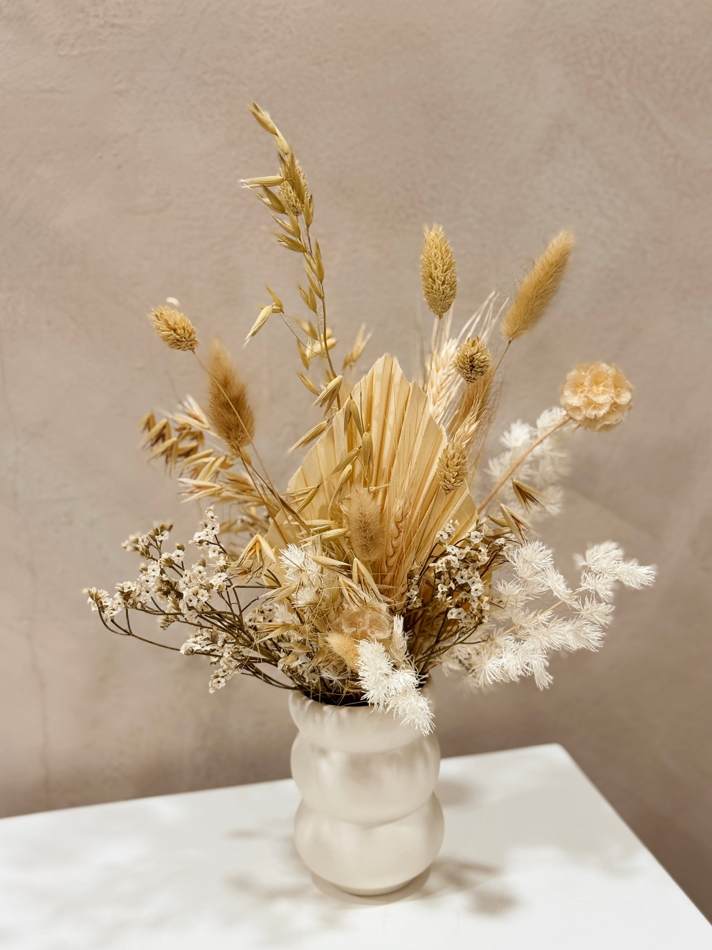 The Ivory Meadow vase arrangement by Eden’s Ground featuring everlasting florals in soft, earthy tones — thoughtfully styled in a matte porcelain vase. Low-maintenance and long-lasting, it's perfect as a housewarming gift or as a timeless piece of home décor.