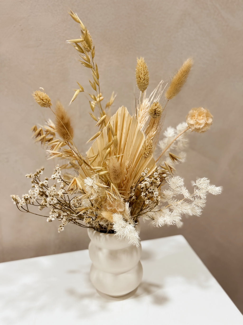 The Ivory Meadow vase arrangement by Eden’s Ground featuring everlasting florals in soft, earthy tones — thoughtfully styled in a matte porcelain vase. Low-maintenance and long-lasting, it's perfect as a housewarming gift or as a timeless piece of home décor.