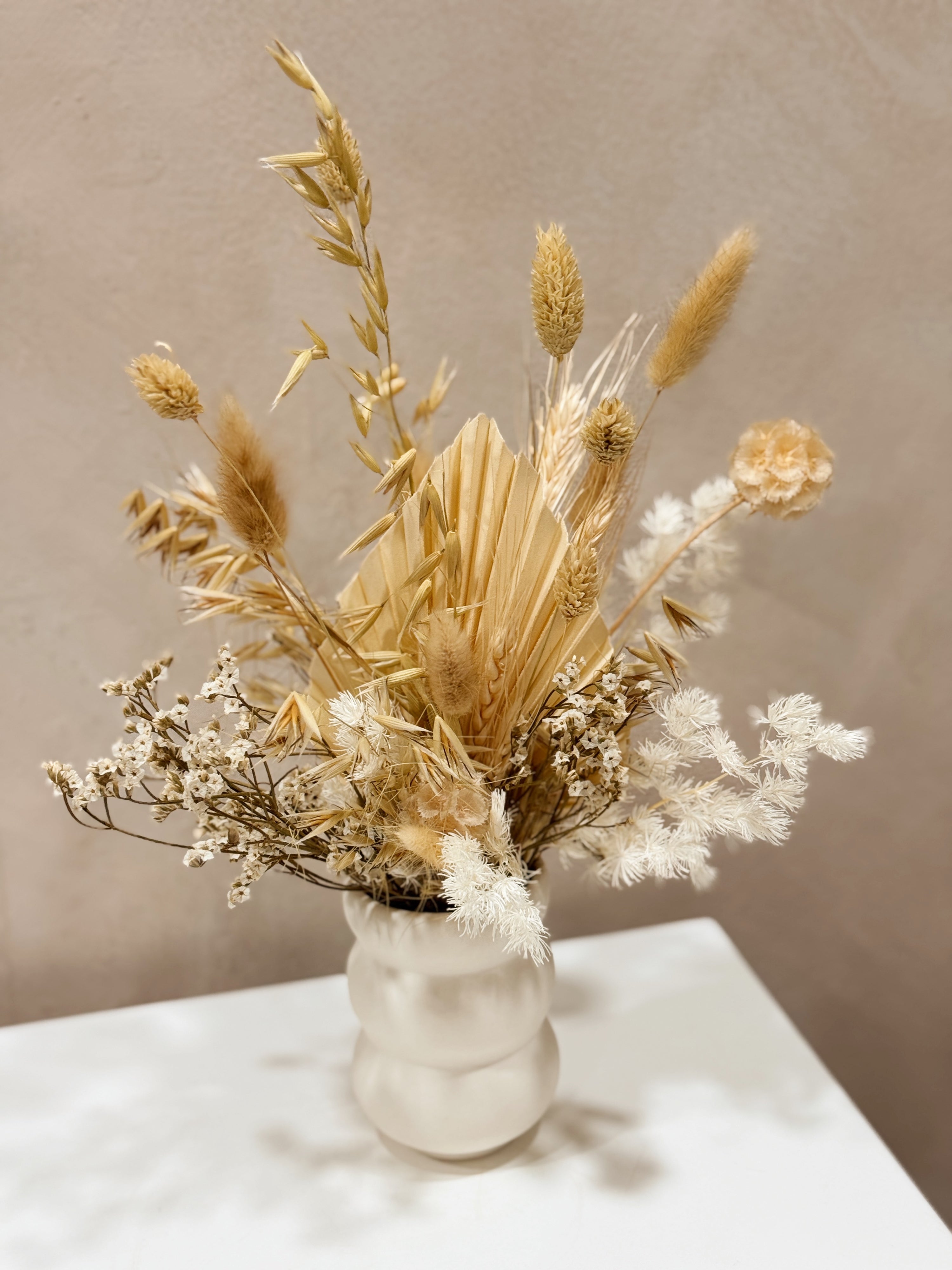 The Ivory Meadow vase arrangement by Eden’s Ground featuring everlasting florals in soft, earthy tones — thoughtfully styled in a matte porcelain vase. Low-maintenance and long-lasting, it's perfect as a housewarming gift or as a timeless piece of home décor.