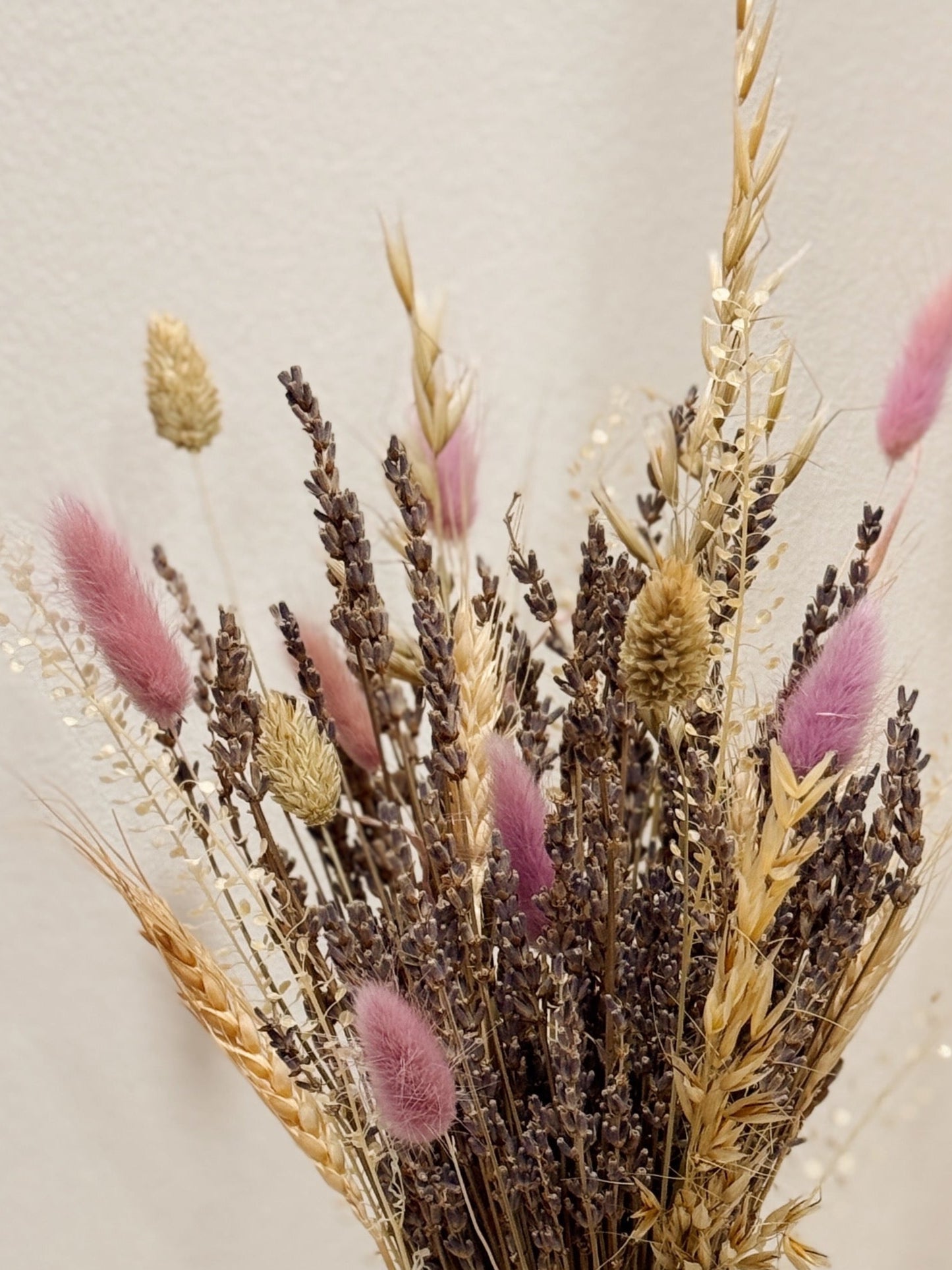 Lavender Bunch is a delicate vase arrangement of dried lavender flowers, gathered in a clear glass vase and tied with a white ribbon, crafted by Eden’s Ground, a floral design boutique.