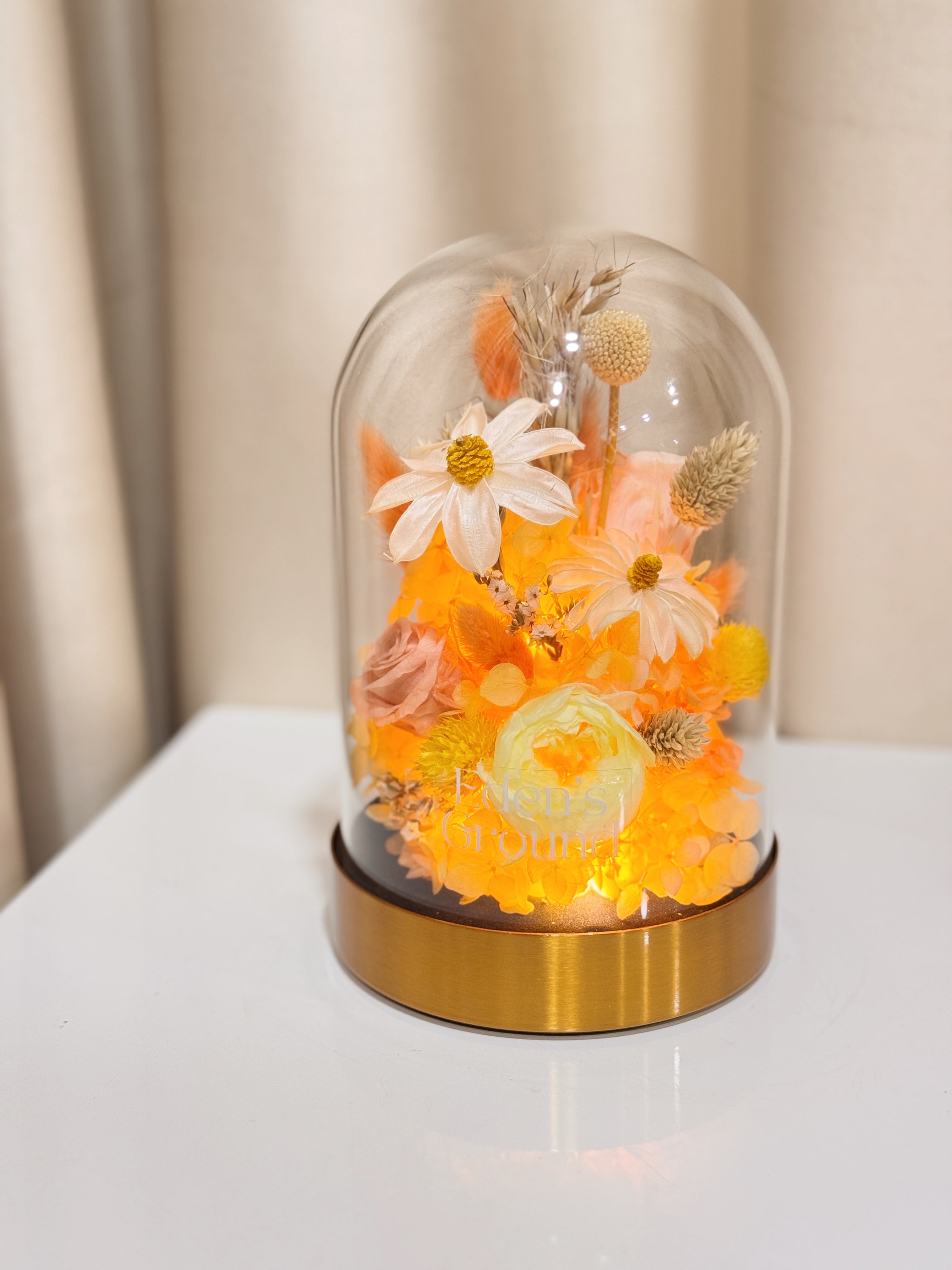 Everlasting Lemon Meringue Flower Dome is made with a delicate blend of preserved cheerful yellow roses, and flowers in a variety of soft pastel colours, beautifully arranged in a glass dome by Eden’s Ground—an unforgettable gift or home decor made to last. 