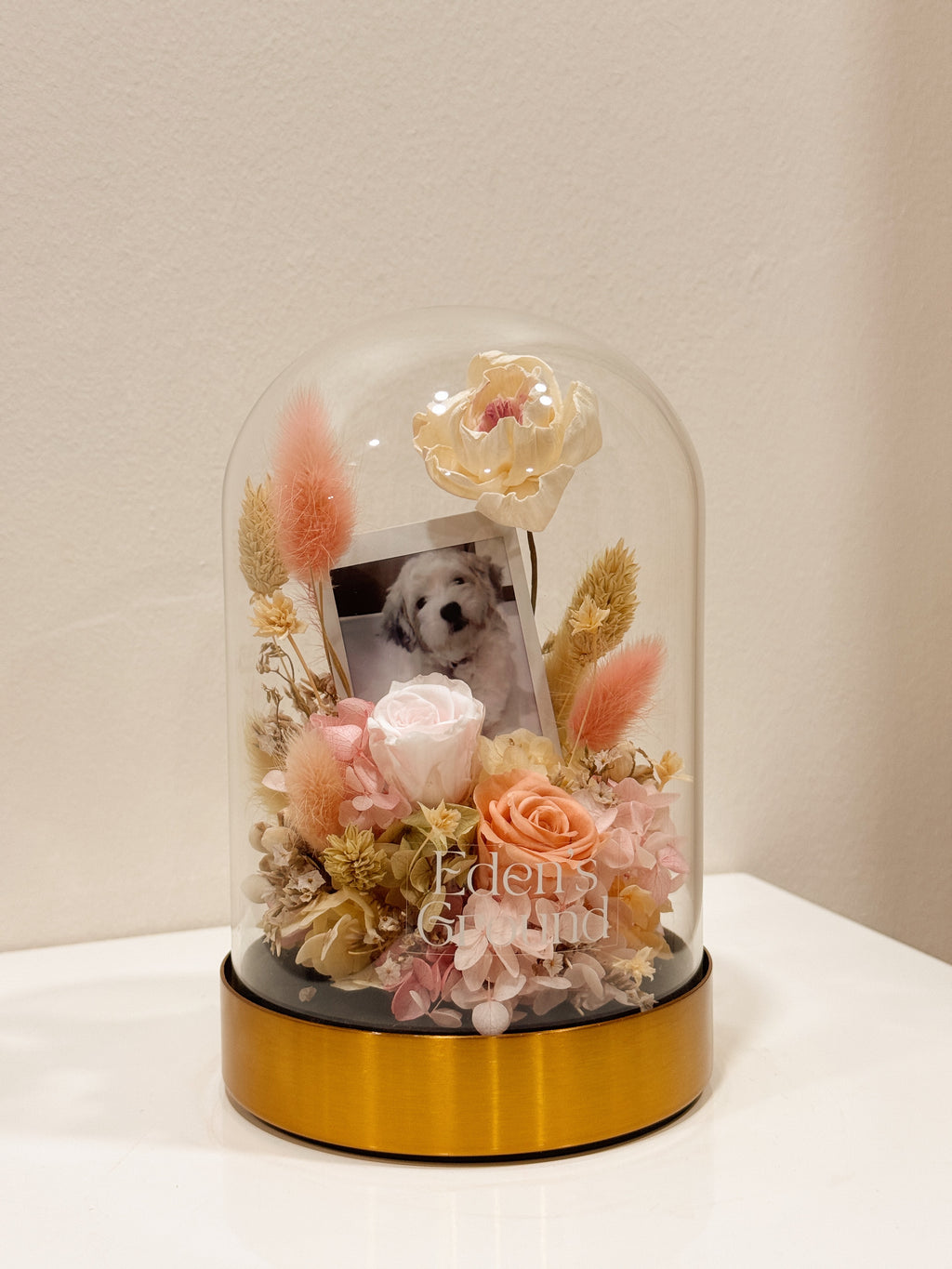 Preserved flower dome with your own photo as a memory capsule, styled in a lighted glass dome on a gold base. Crafted by Eden's Ground, a floral design boutique.